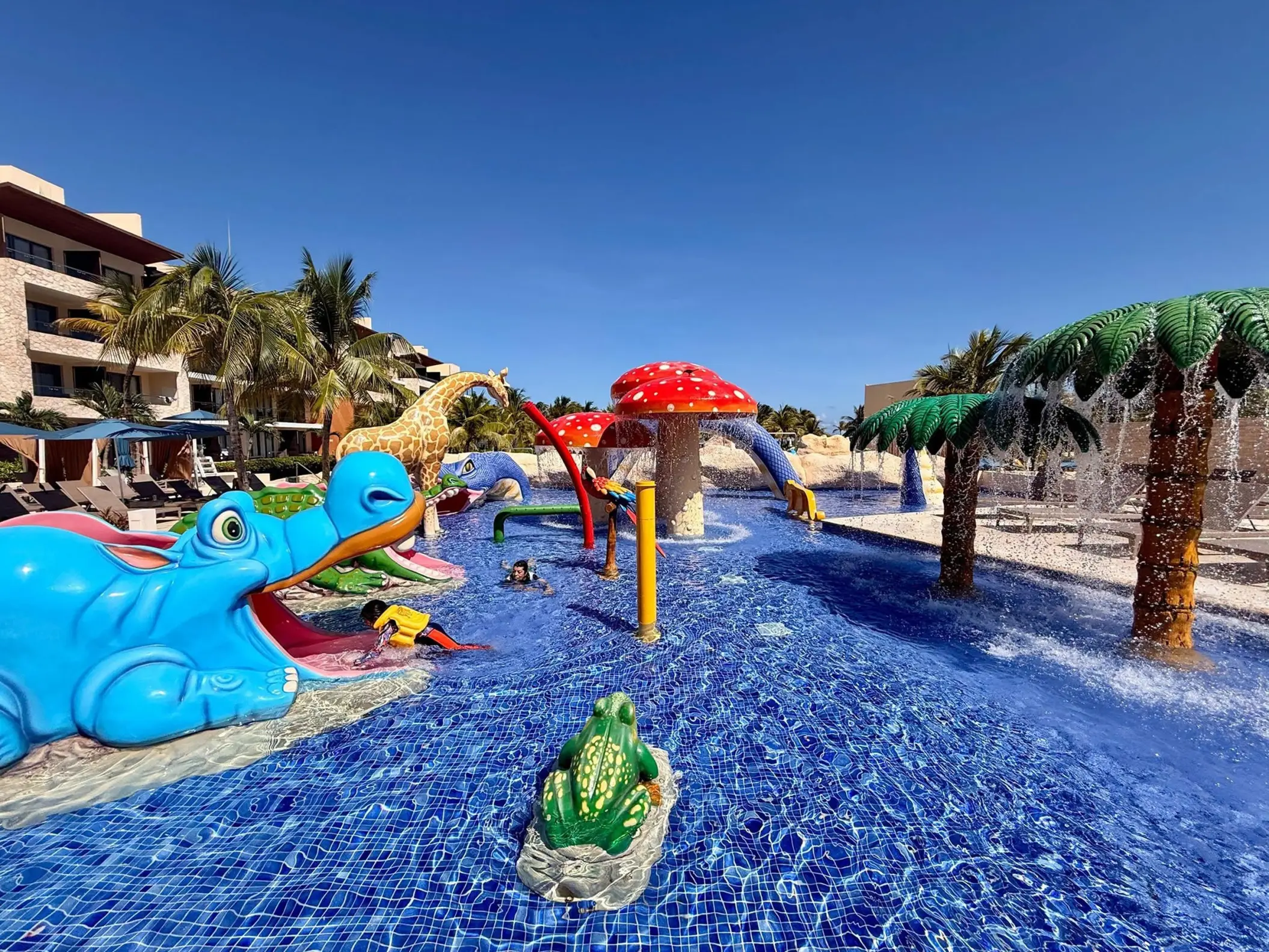 Colorful kids splash pool with animal slides and water fountains at Royalton Riviera Cancun, Cancun