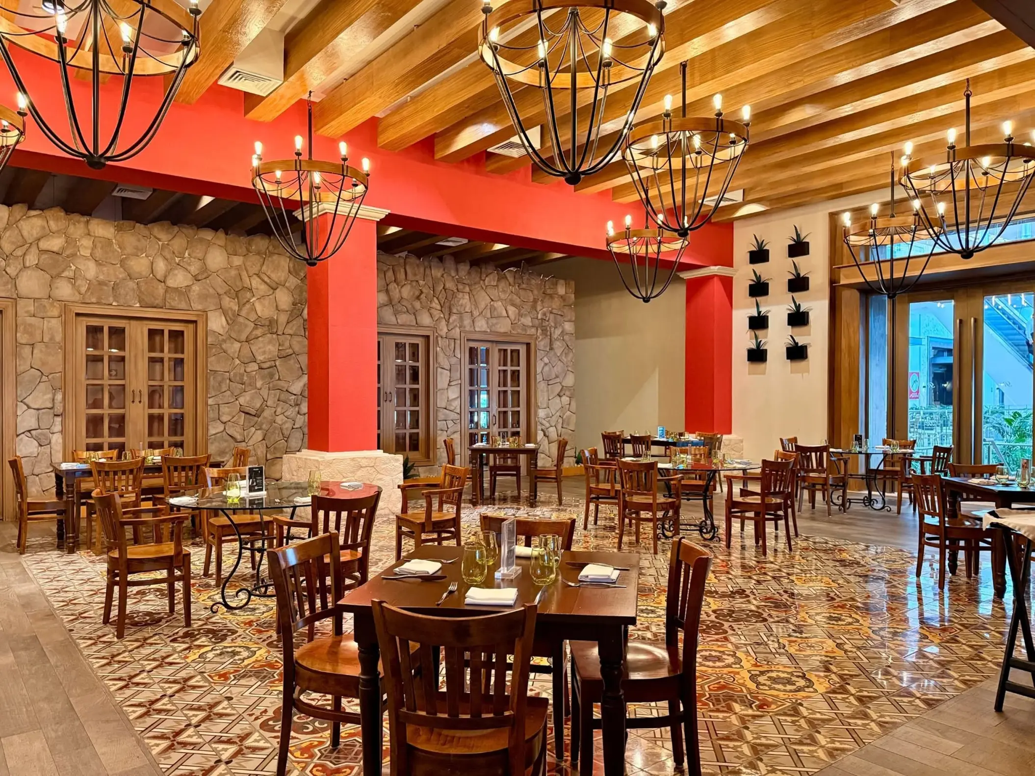 Indoor restaurant dining area with wooden beams and stone walls at Royalton Riviera Cancun, Cancun