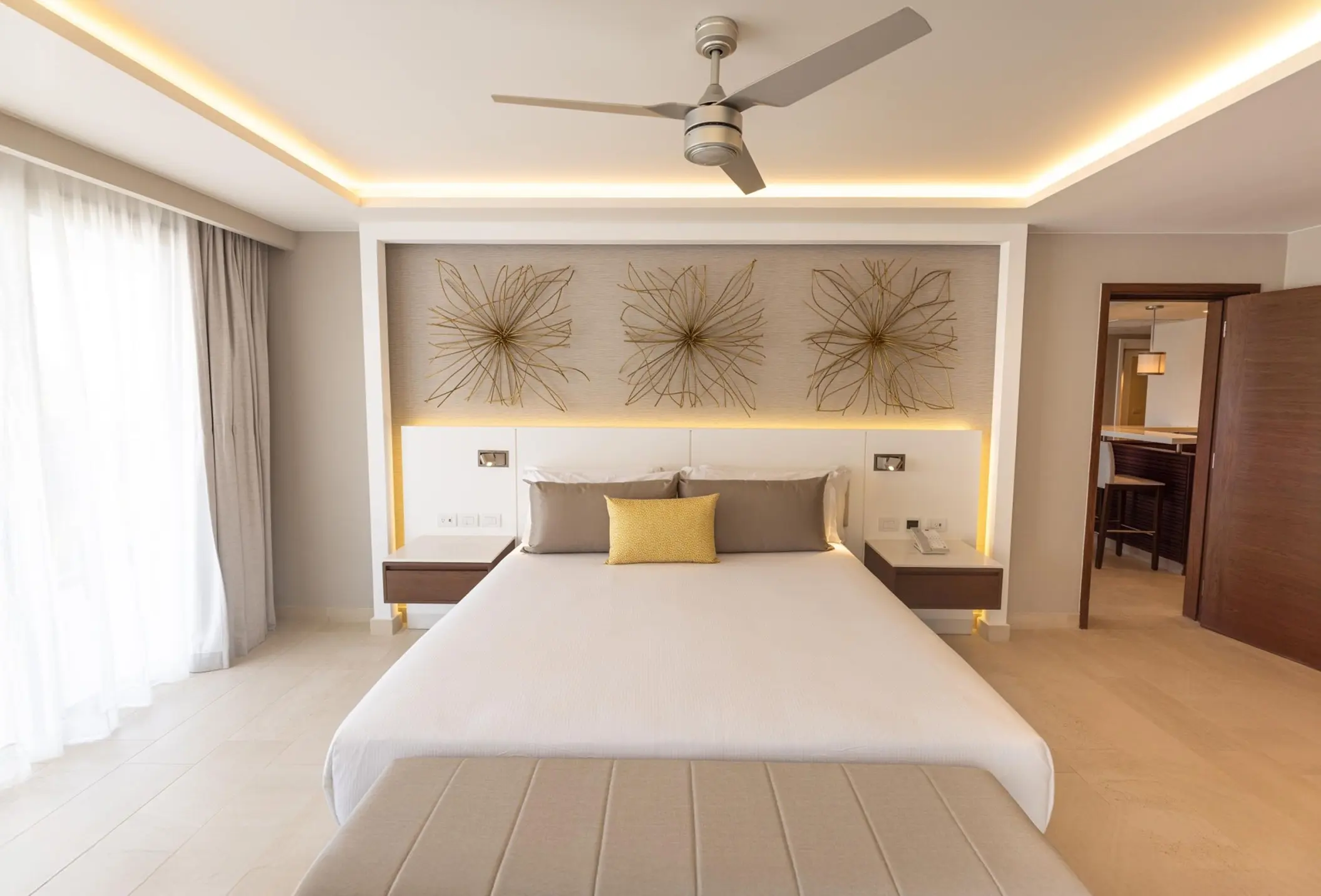 Modern suite with a king bed and wall art at Royalton Riviera Cancun, Cancun