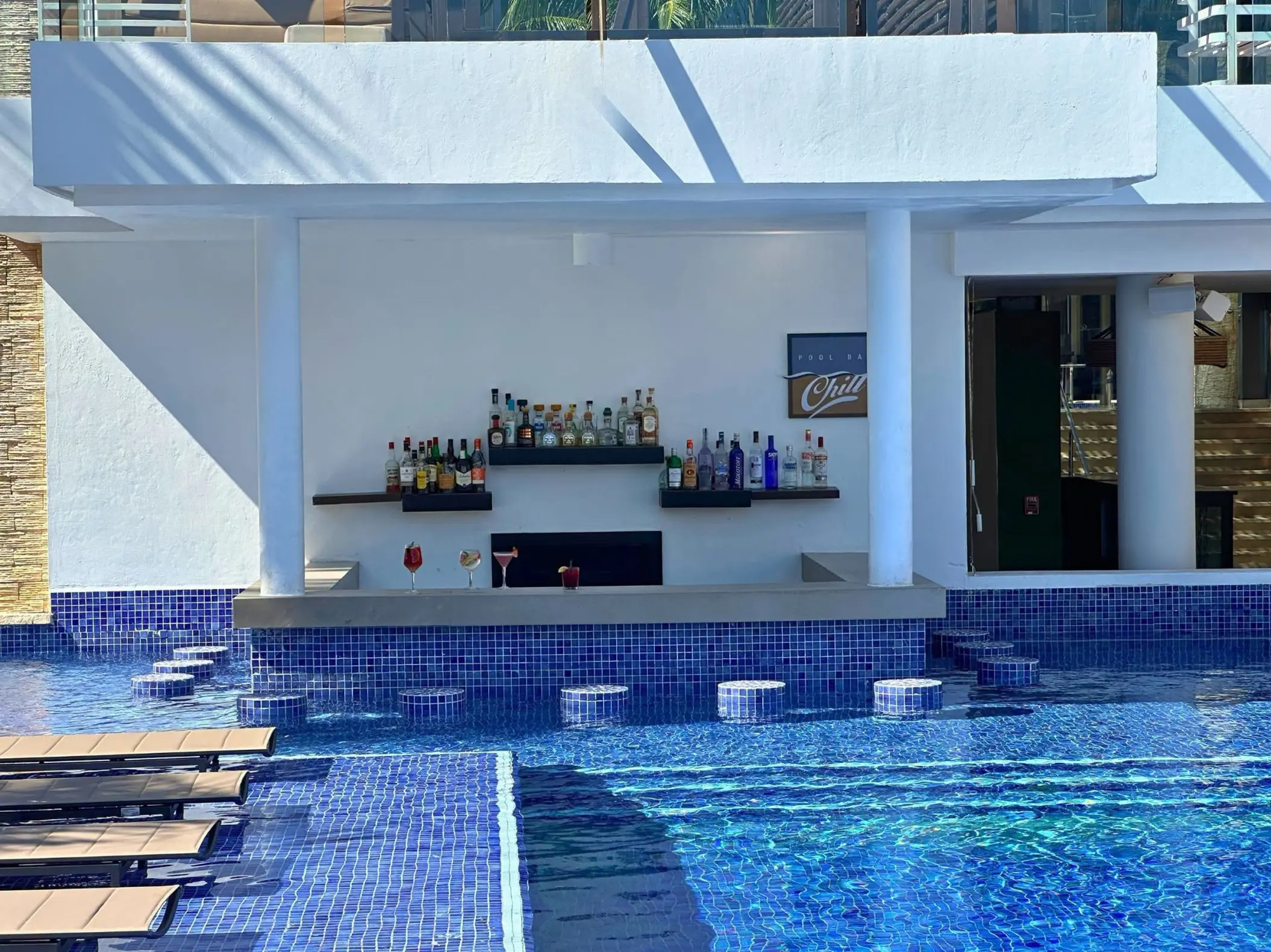 Swim-up bar with blue tiled stools in the pool at Royalton Riviera Cancun, Cancun