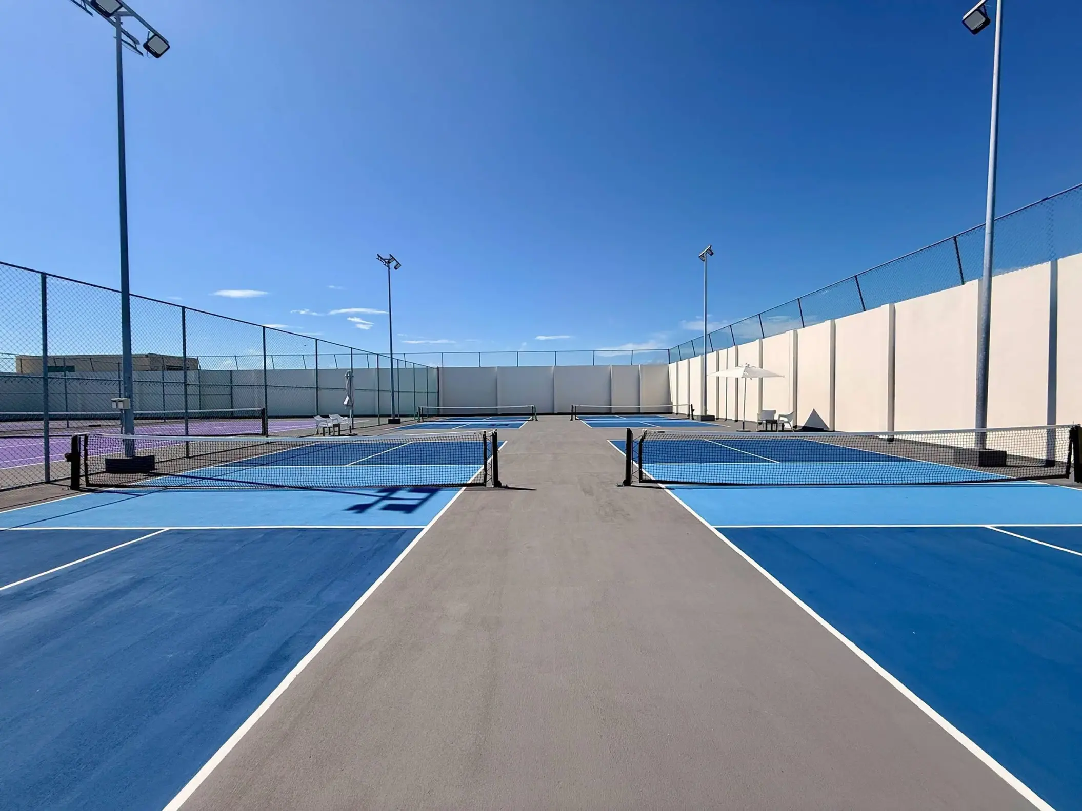 Blue outdoor tennis courts at Royalton Riviera Cancun