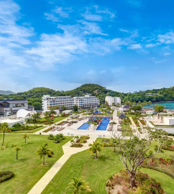 Aerial view of Royalton Saint Lucia grounds, pools, and lawns along the coast in Castries