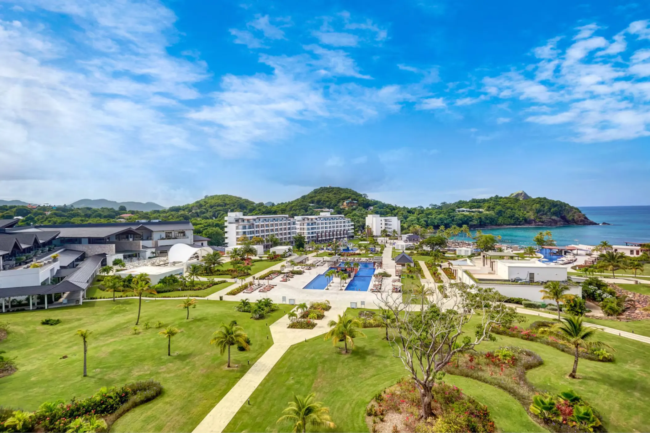 Aerial view of Royalton Saint Lucia grounds, pools, and lawns along the coast in Castries