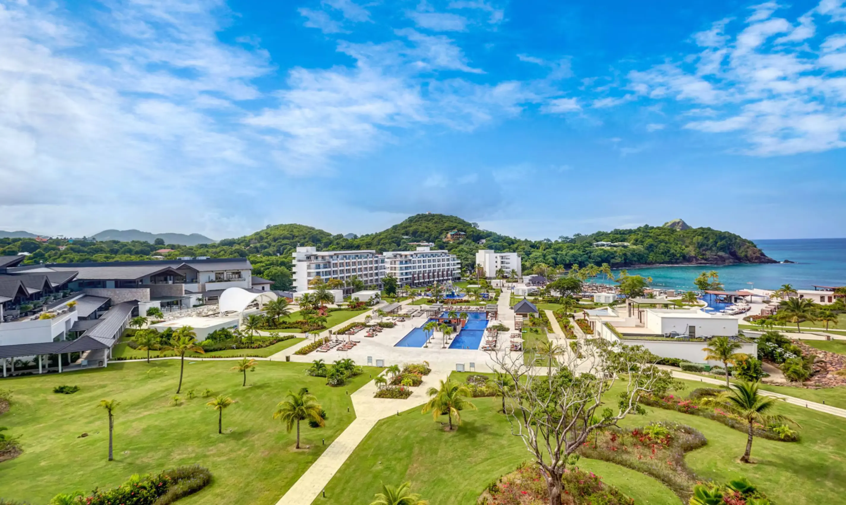 Aerial view of Royalton Saint Lucia grounds, pools, and lawns along the coast in Castries