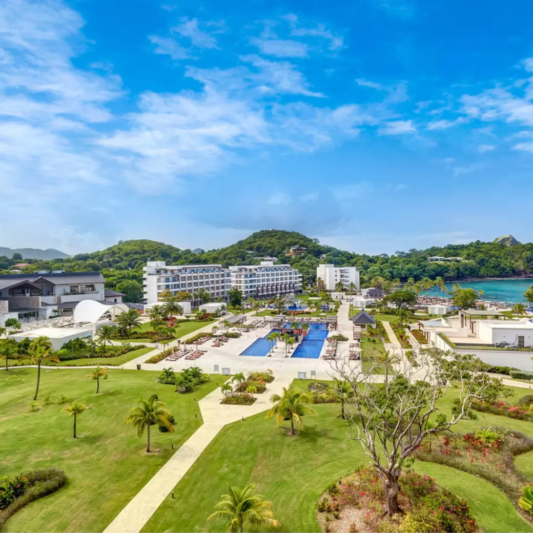 Aerial view of Royalton Saint Lucia grounds, pools, and lawns along the coast in Castries