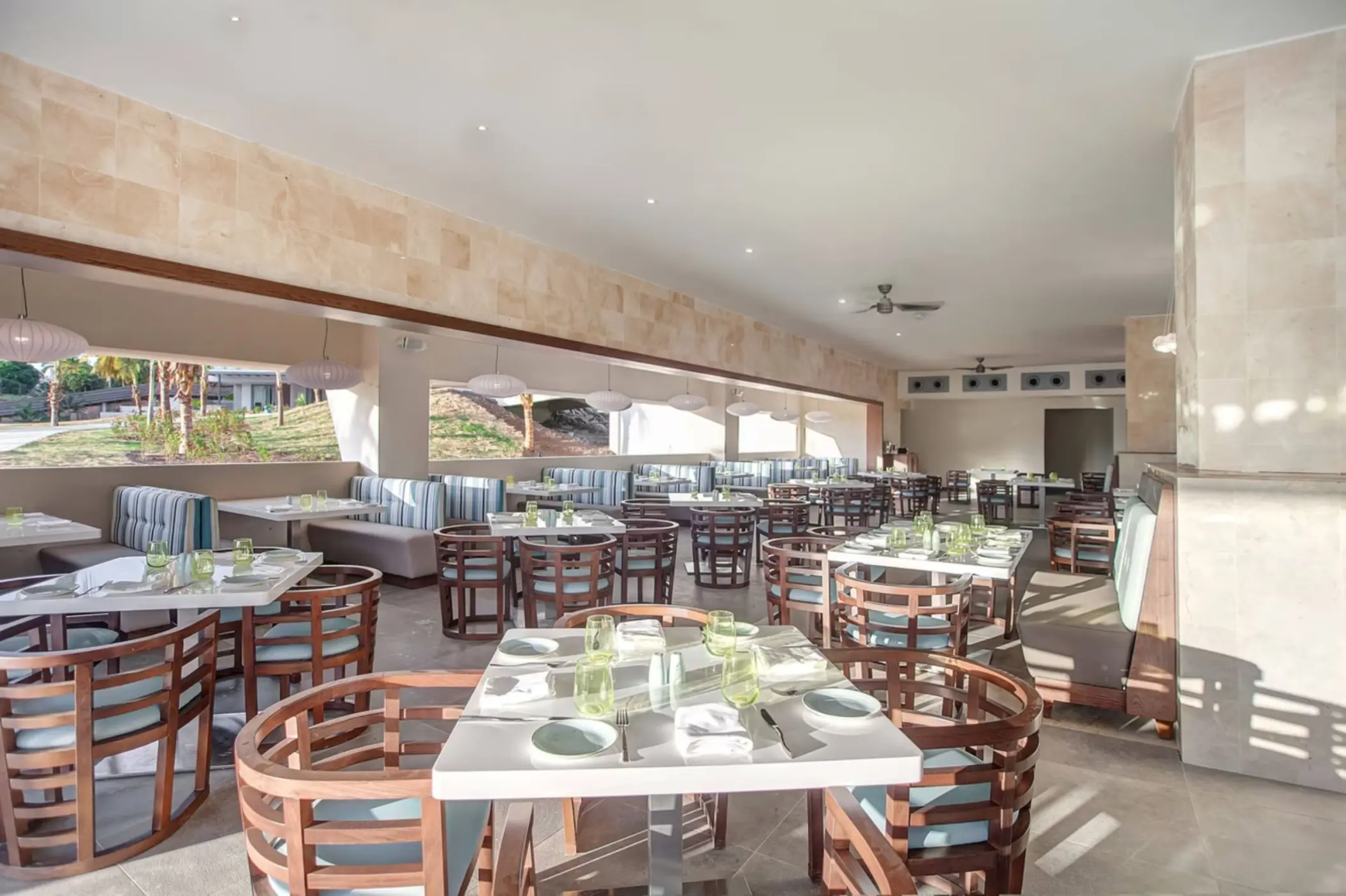 Grazie Italian Restaurant dining room with wooden chairs and white tables at Royalton Saint Lucia, Castries
