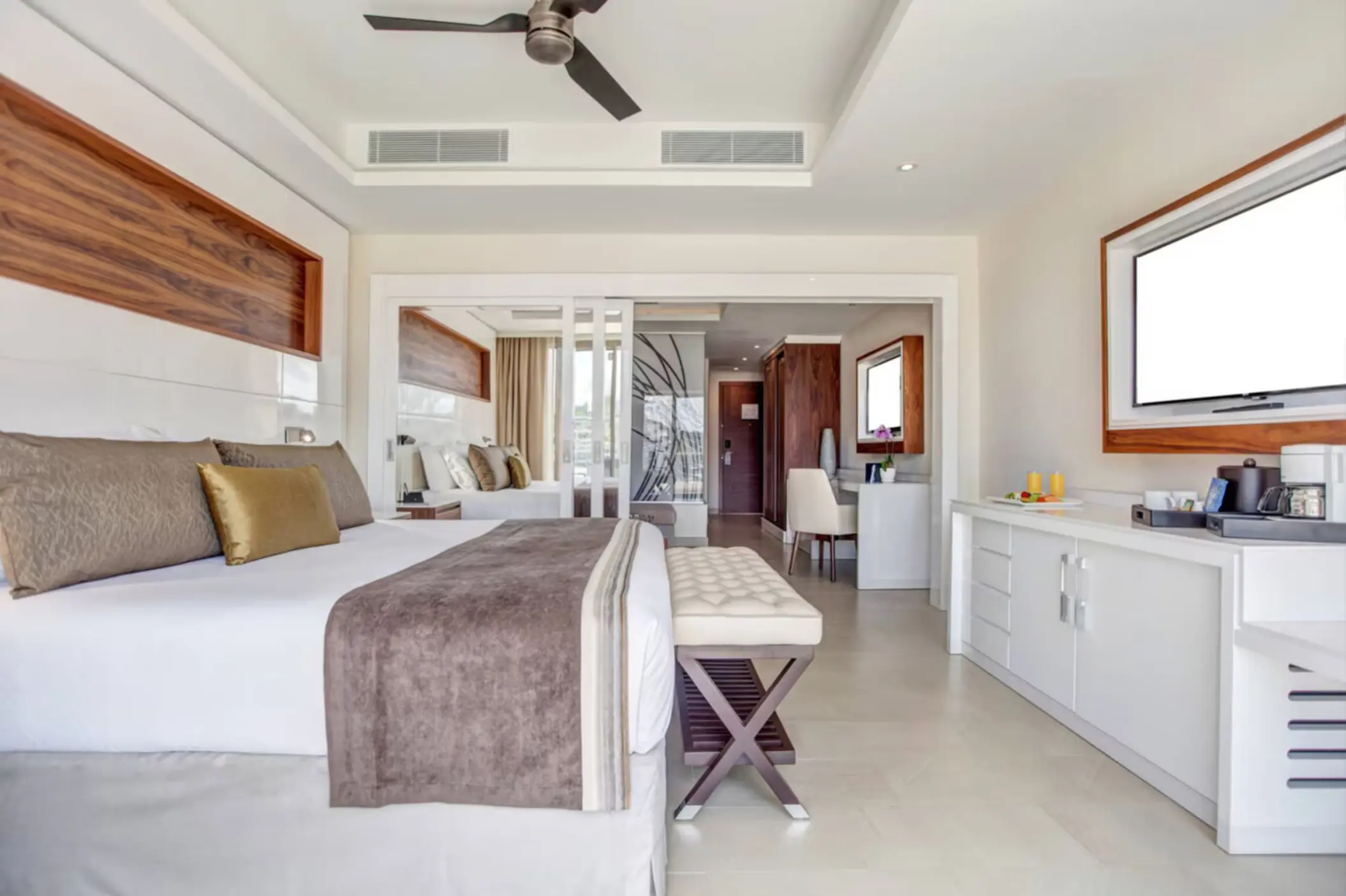 Luxury family suite with a king bed and modern white furniture at Royalton Saint Lucia, Castries