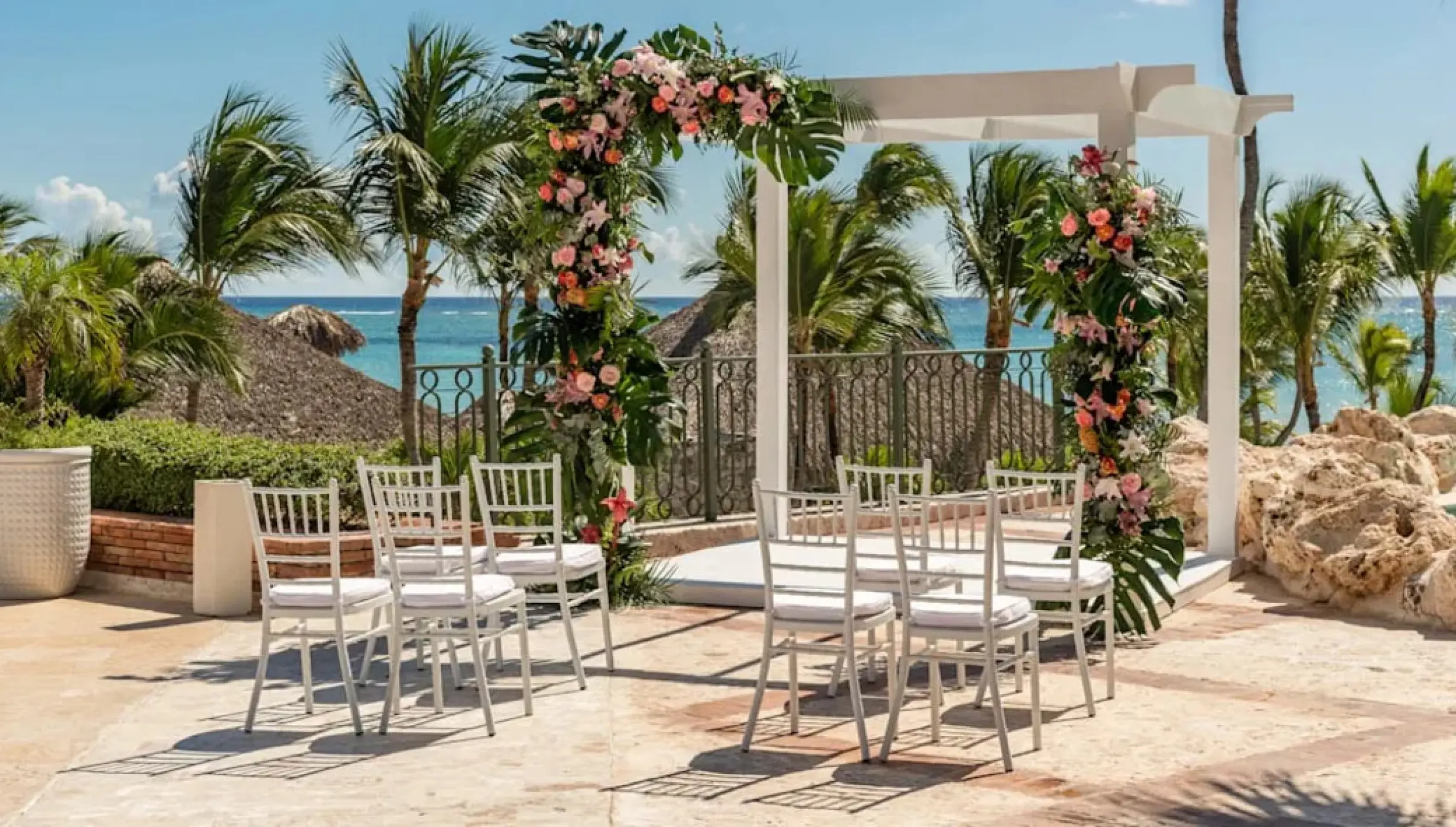 Floral ceremony arch and white chairs at Sanctuary Cap Cana, Punta Cana