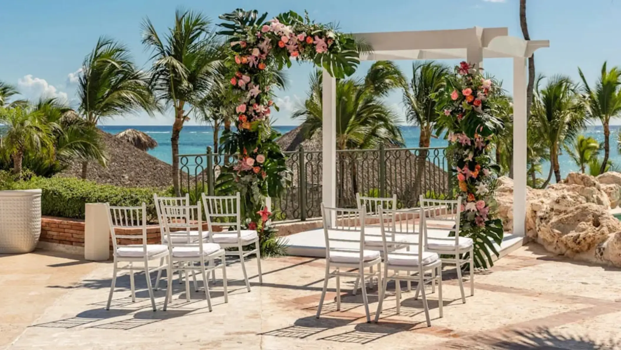Floral ceremony arch and white chairs at Sanctuary Cap Cana, Punta Cana