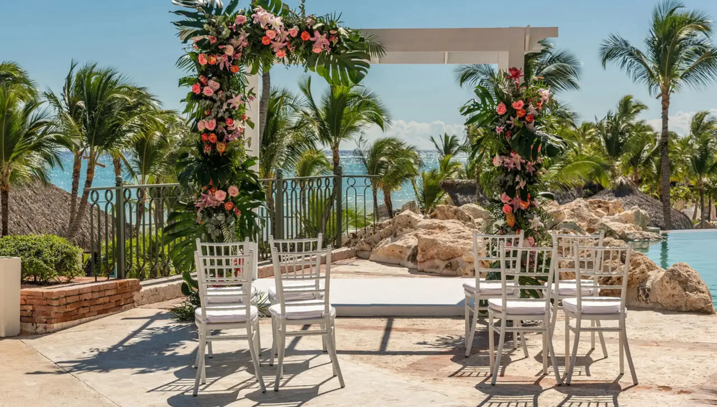 Floral garden wedding ceremony setup on a terrace at Sanctuary Cap Cana, Punta Cana