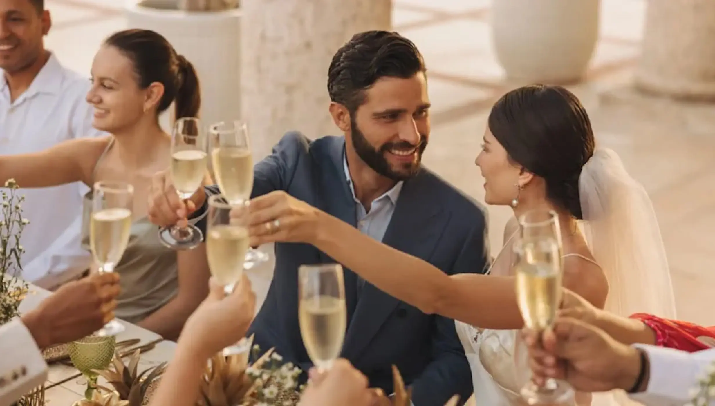 The couple and guests toasting with champagne at a Sanctuary Cap Cana wedding reception, Punta Cana