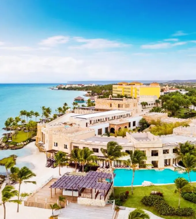 Aerial view of the beachfront pools and castle-style architecture at Sanctuary Cap Cana, Punta Cana