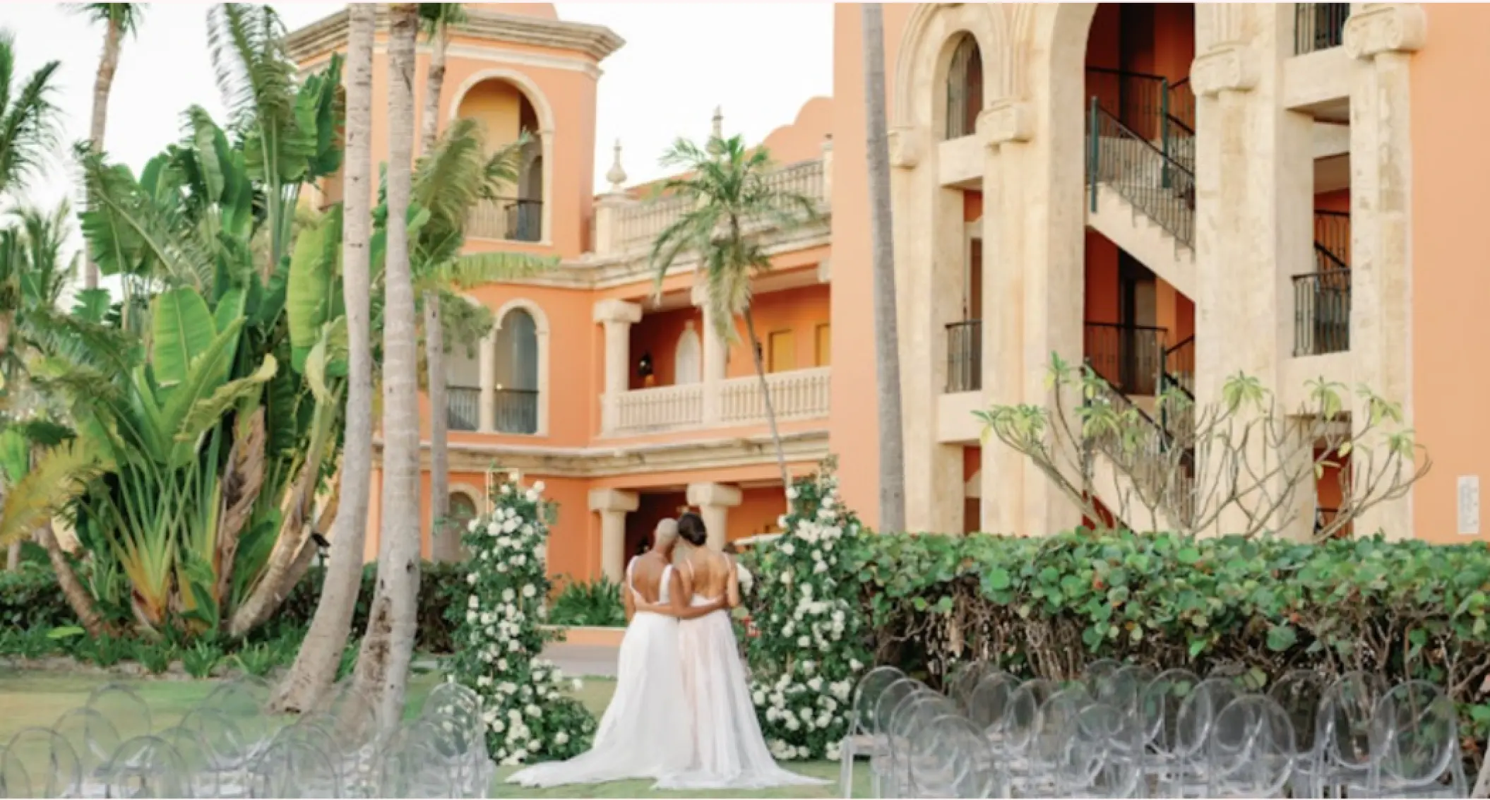 Two brides standing at a garden wedding ceremony venue at Sanctuary Cap Cana, Punta Cana