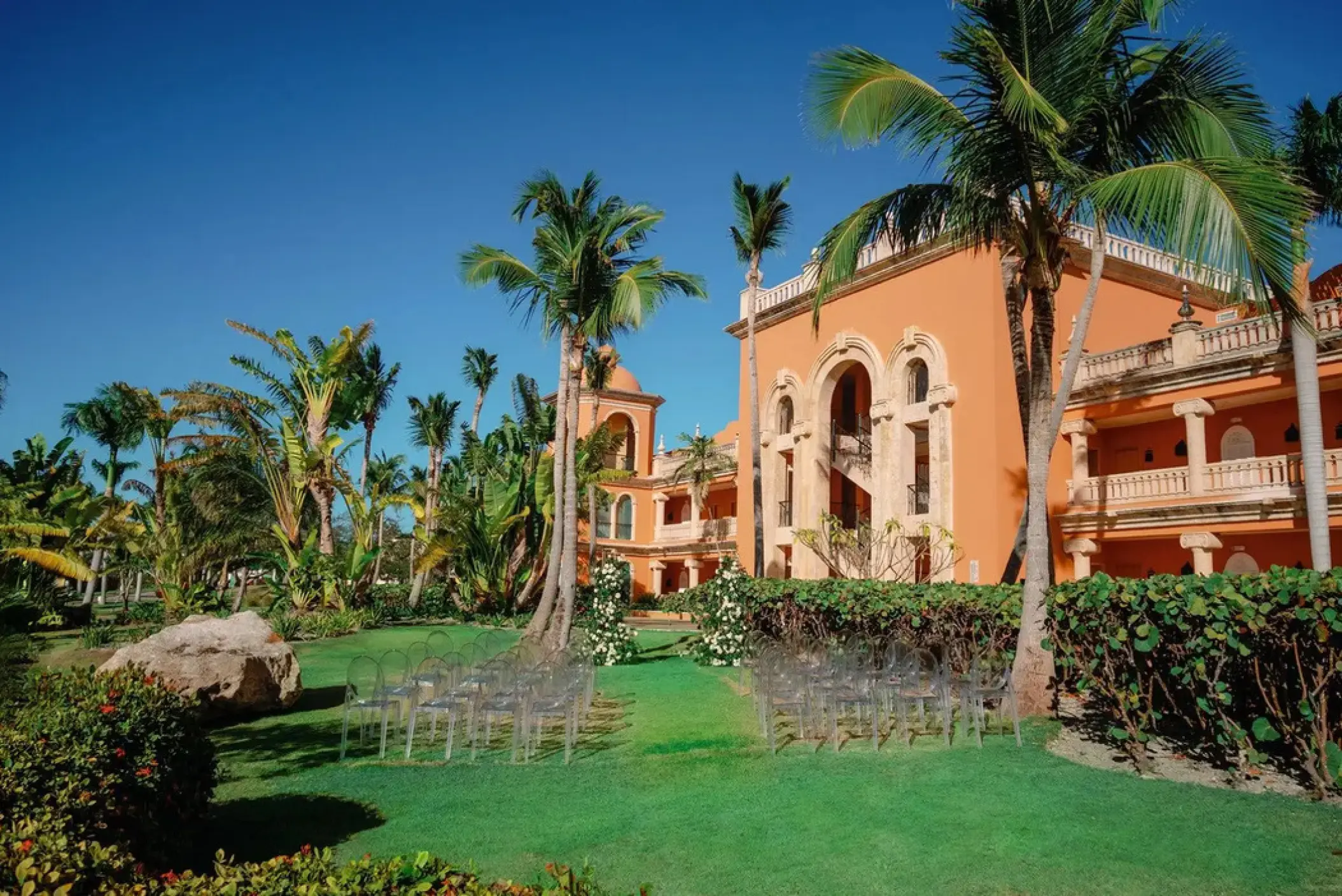 Garden wedding ceremony setup with ghost chairs at Sanctuary Cap Cana, Punta Cana