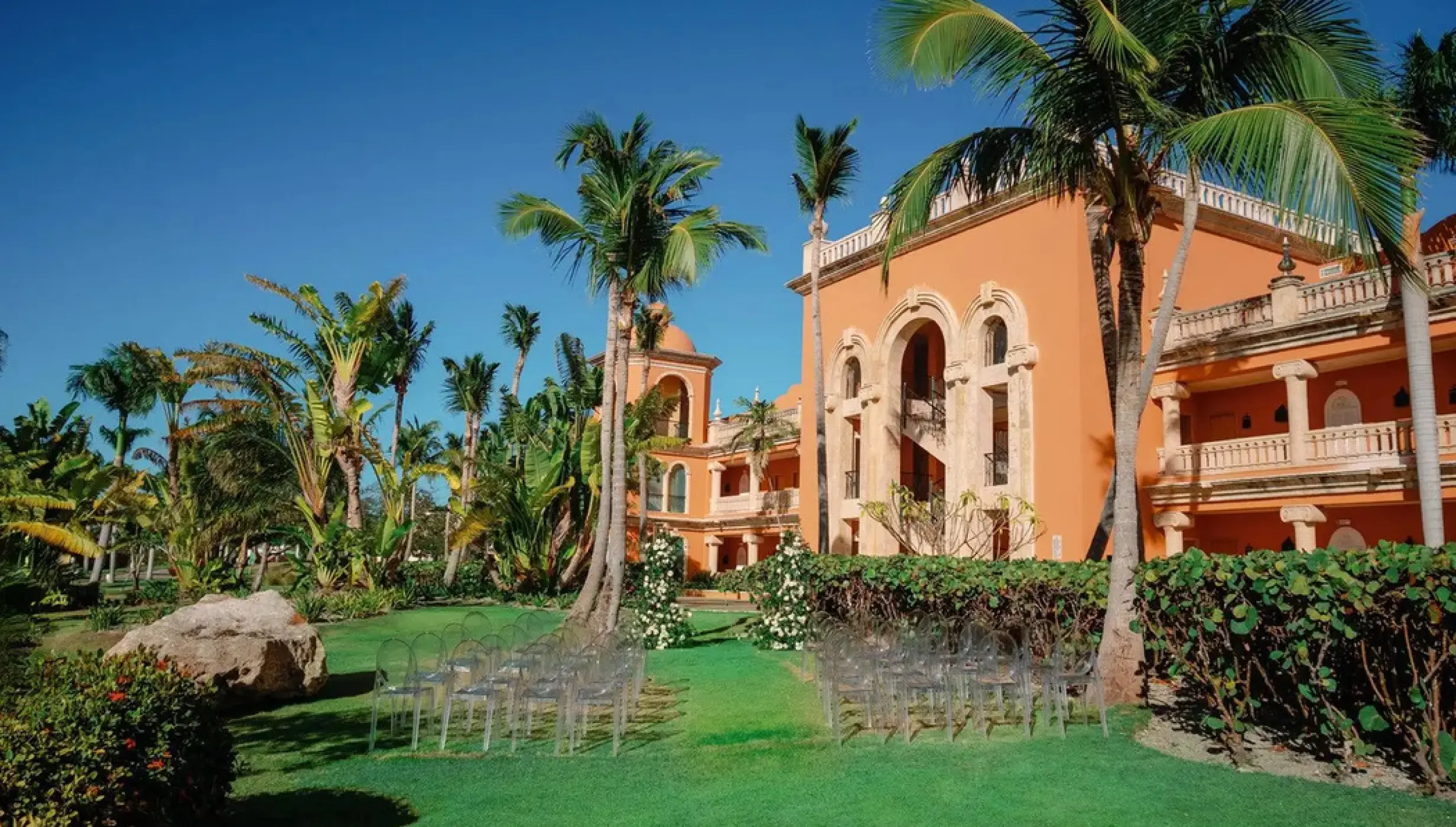 Garden wedding ceremony setup with ghost chairs at Sanctuary Cap Cana, Punta Cana