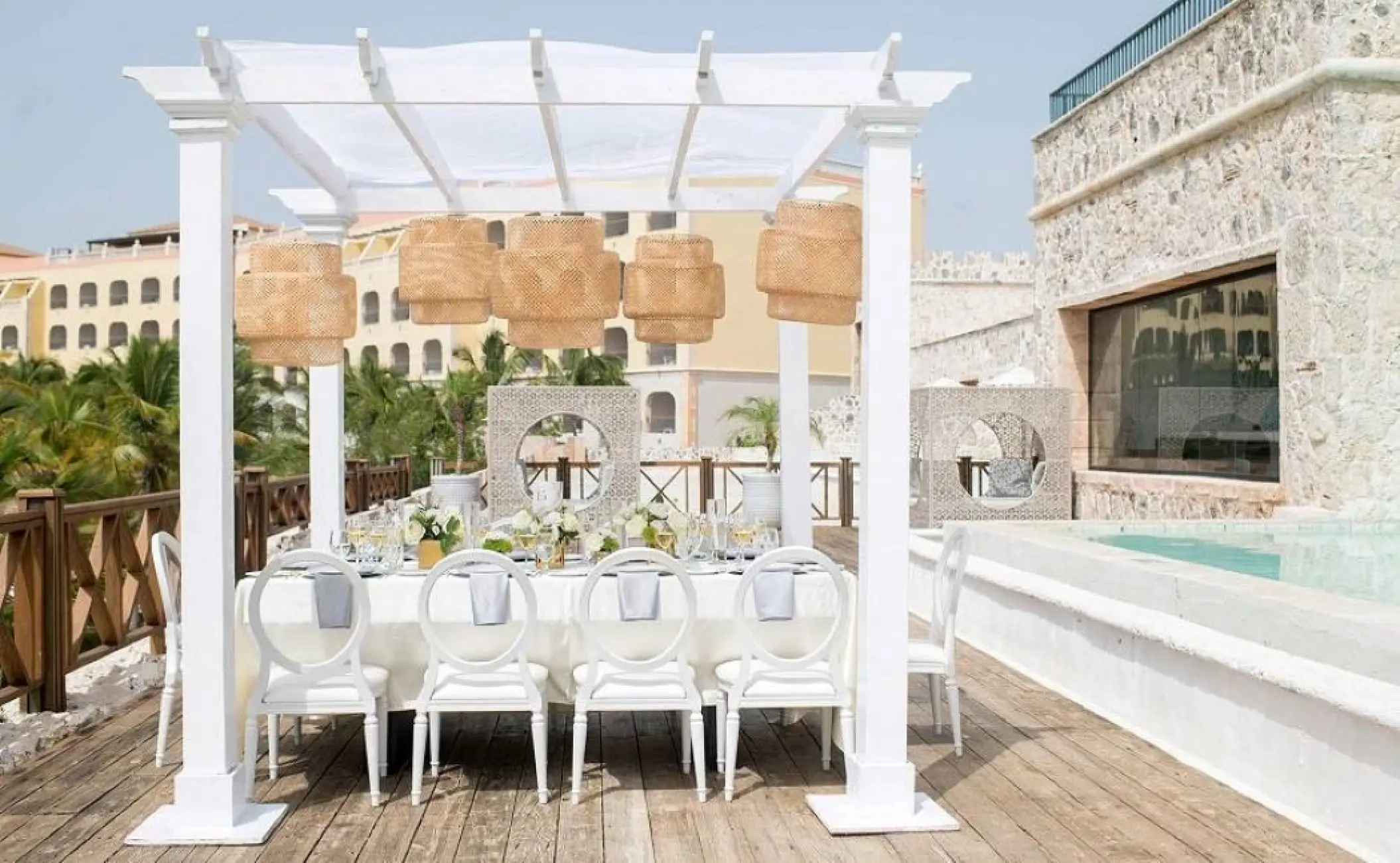 The Castle Ocean Lounge wedding reception venue under a white pergola at Sanctuary Cap Cana, Punta Cana