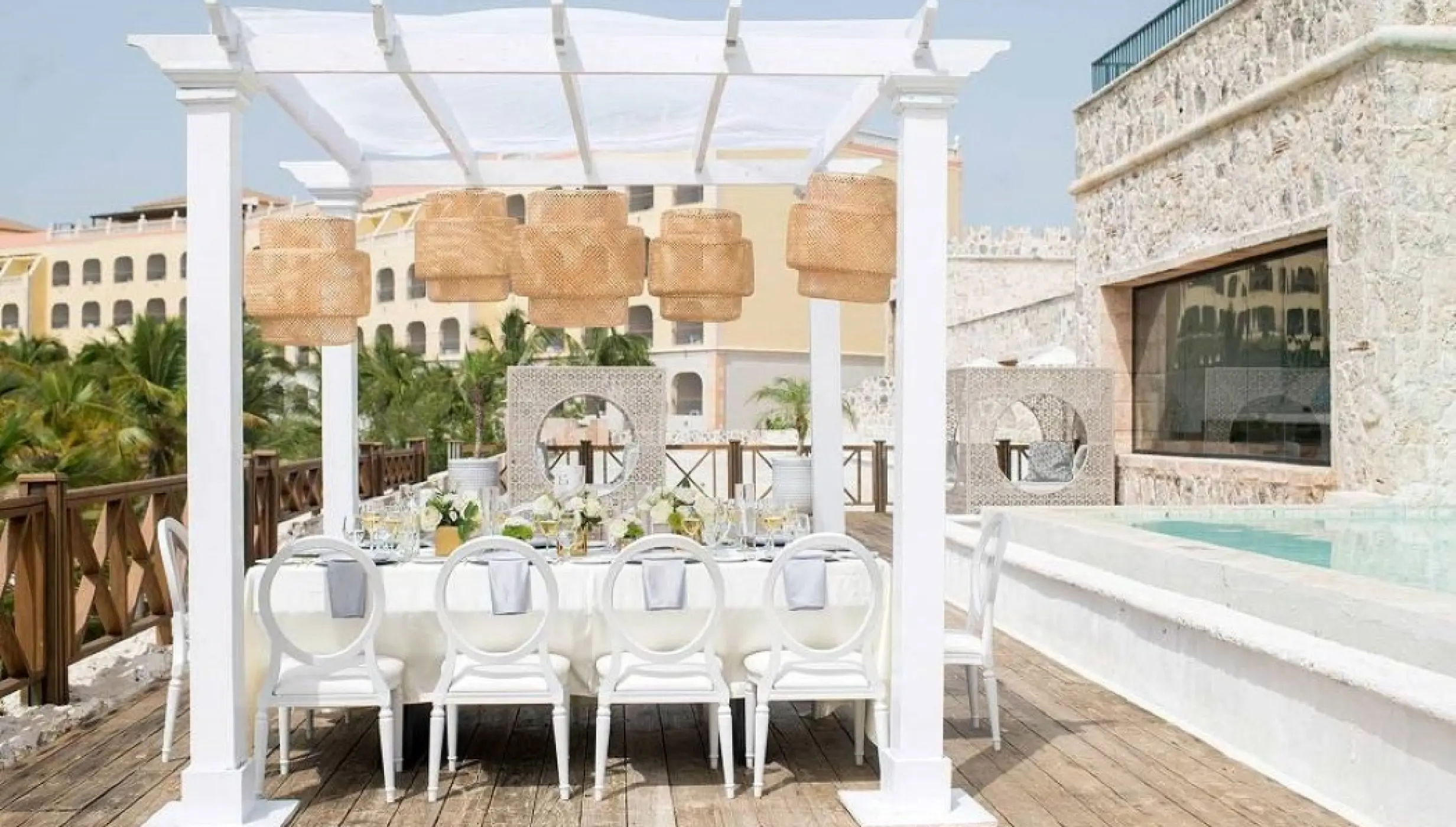 The Castle Ocean Lounge wedding reception venue under a white pergola at Sanctuary Cap Cana, Punta Cana
