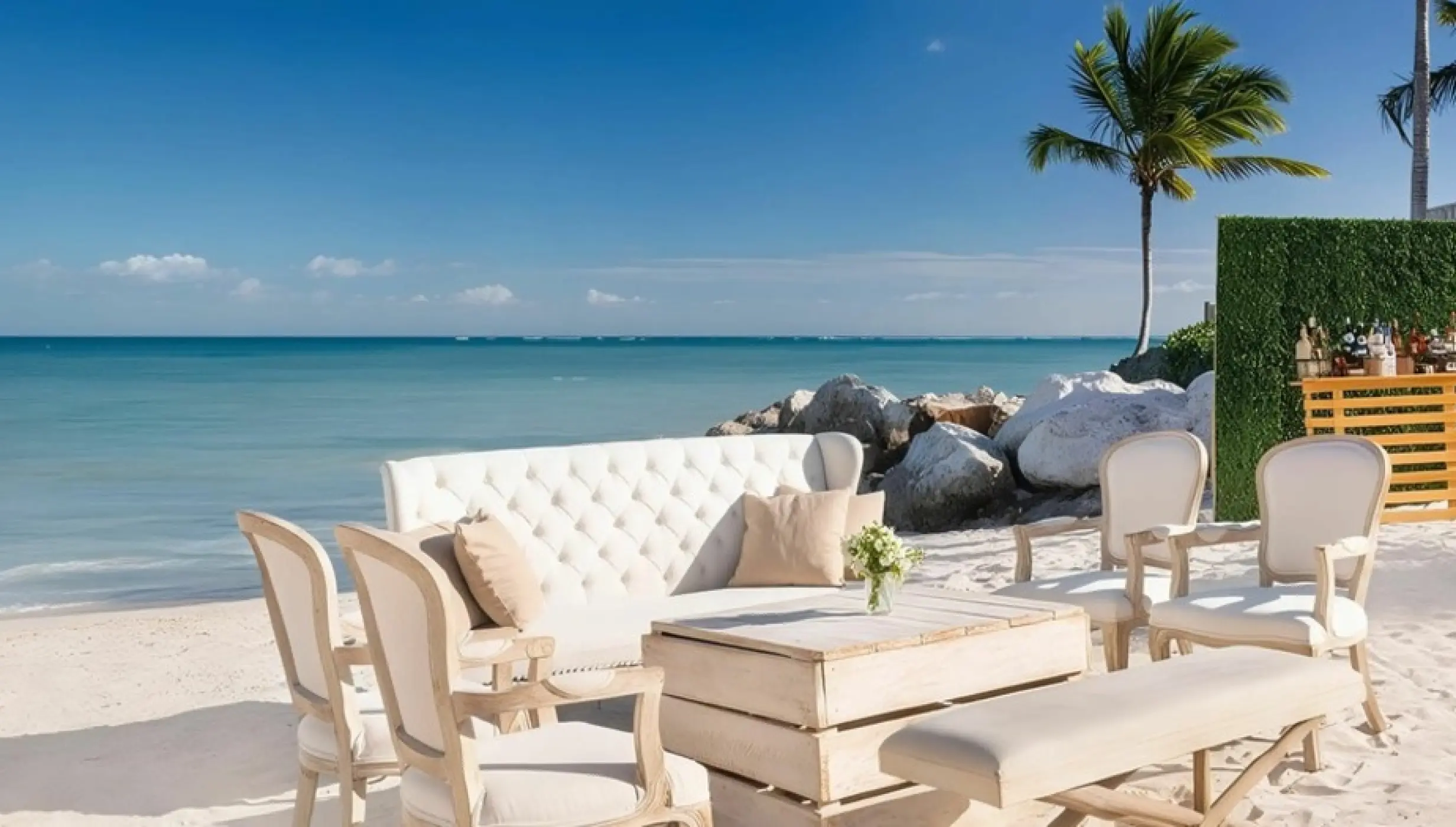Beachfront wedding reception lounge with white seating and bar at Sanctuary Cap Cana, Punta Cana