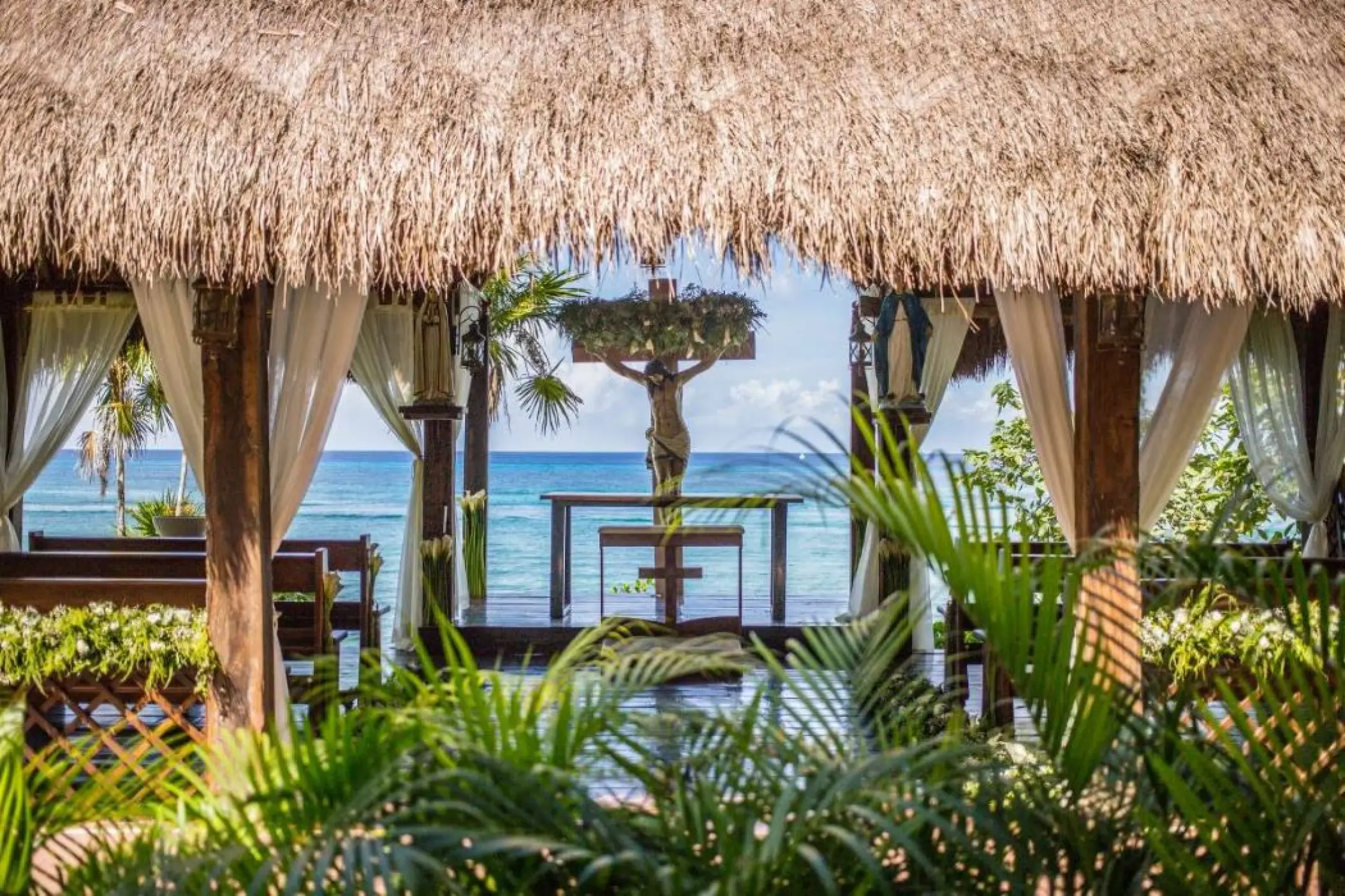 Catholic chapel wedding ceremony venue under a palapa roof at Dreams Cozumel Cape, Cozumel