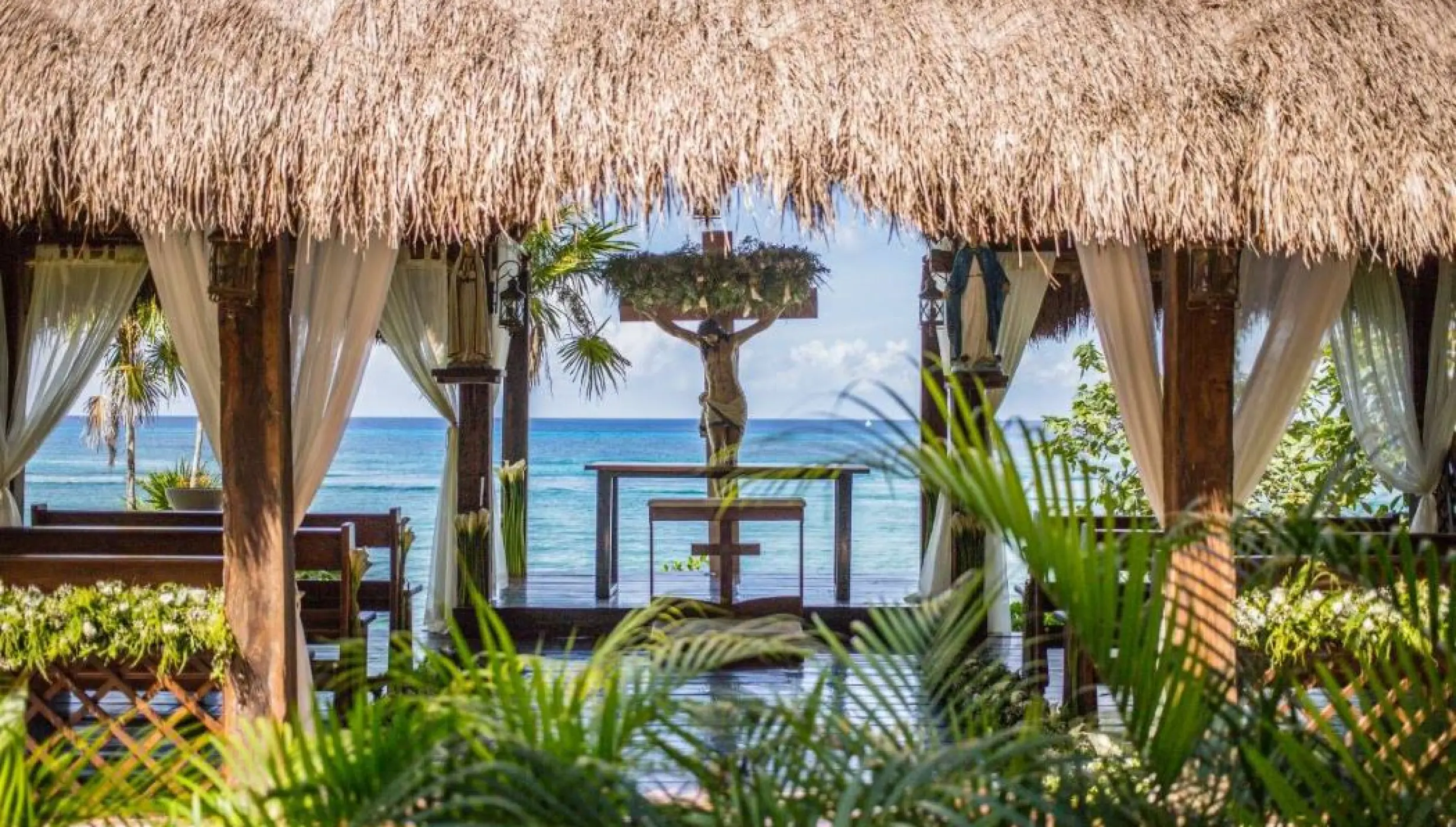 Catholic chapel wedding ceremony venue under a palapa roof at Dreams Cozumel Cape, Cozumel