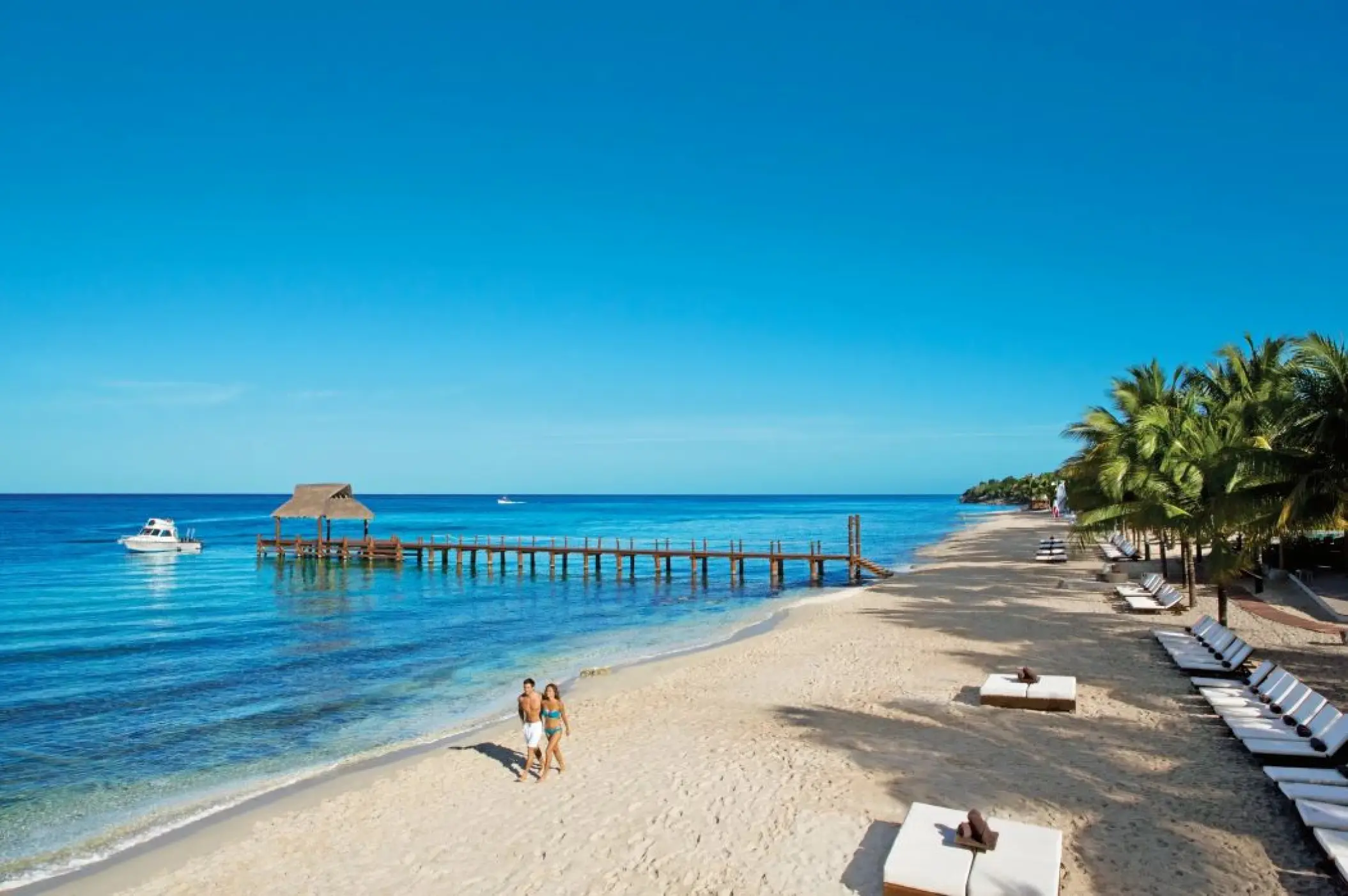 Couple walking along the beach at Secrets Aura Cozumel, Cozumel