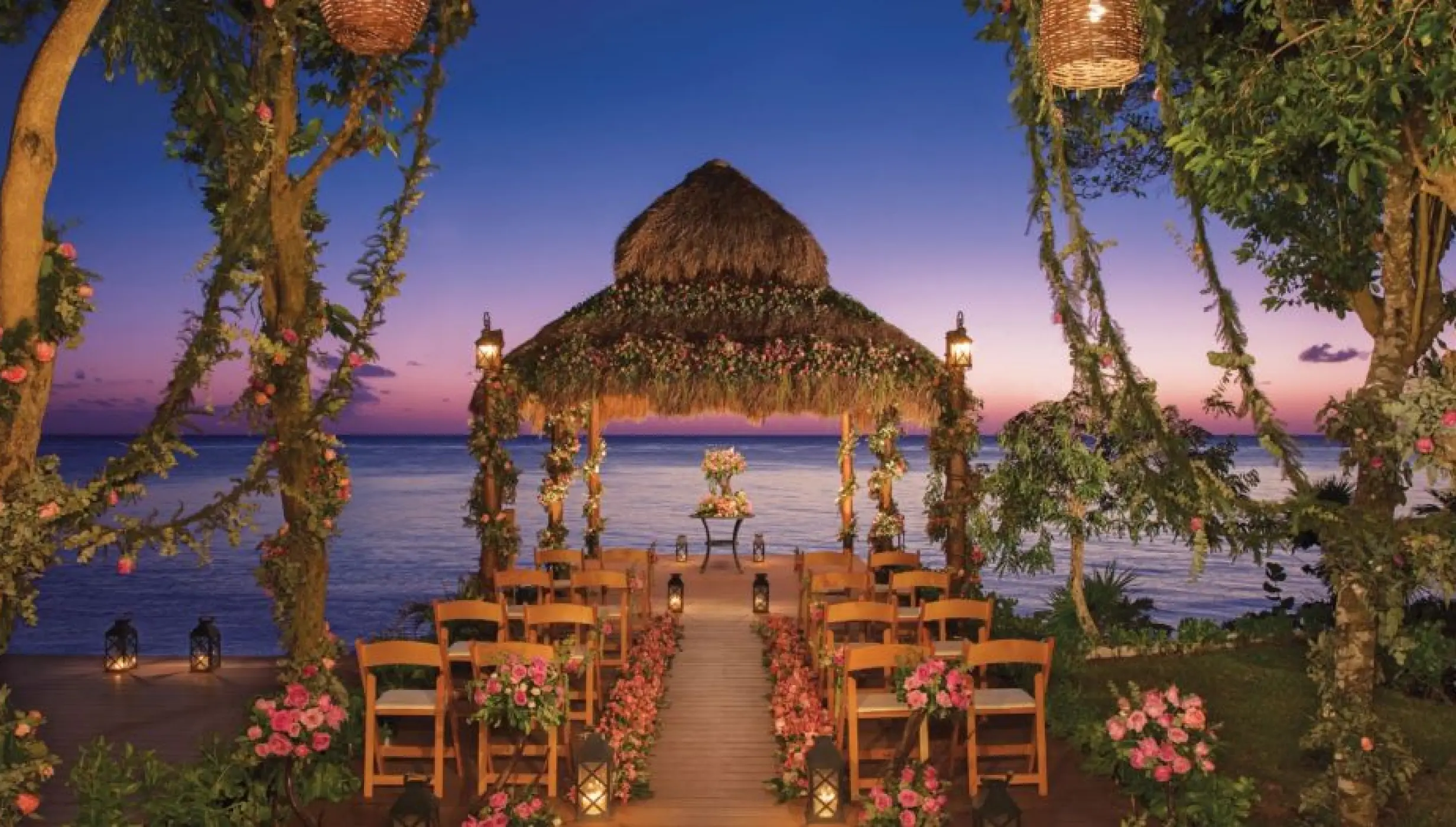 Thatched roof wedding ceremony gazebo at sunset, Dreams Cozumel Cape