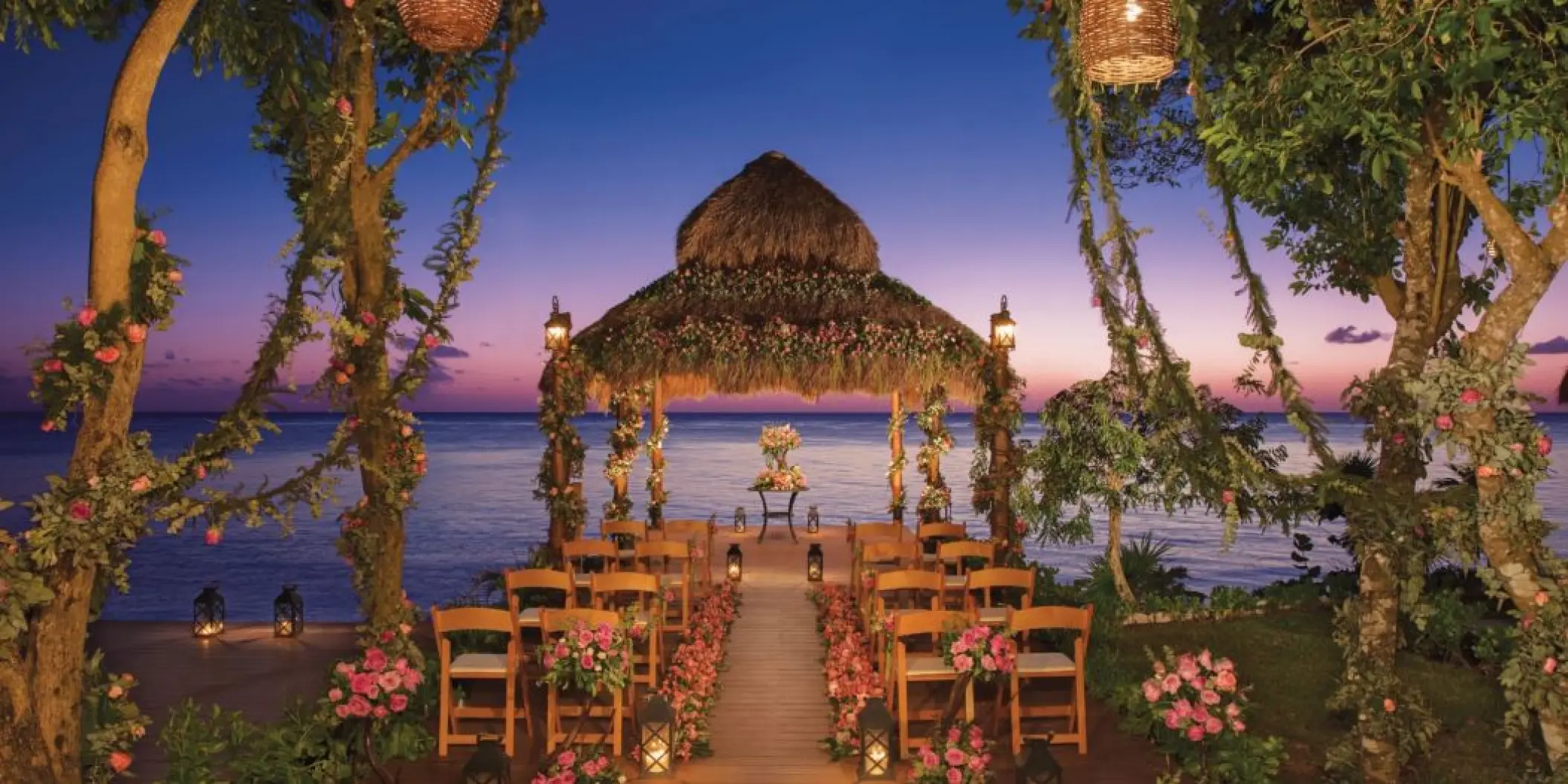 Thatched roof wedding ceremony gazebo at sunset, Dreams Cozumel Cape