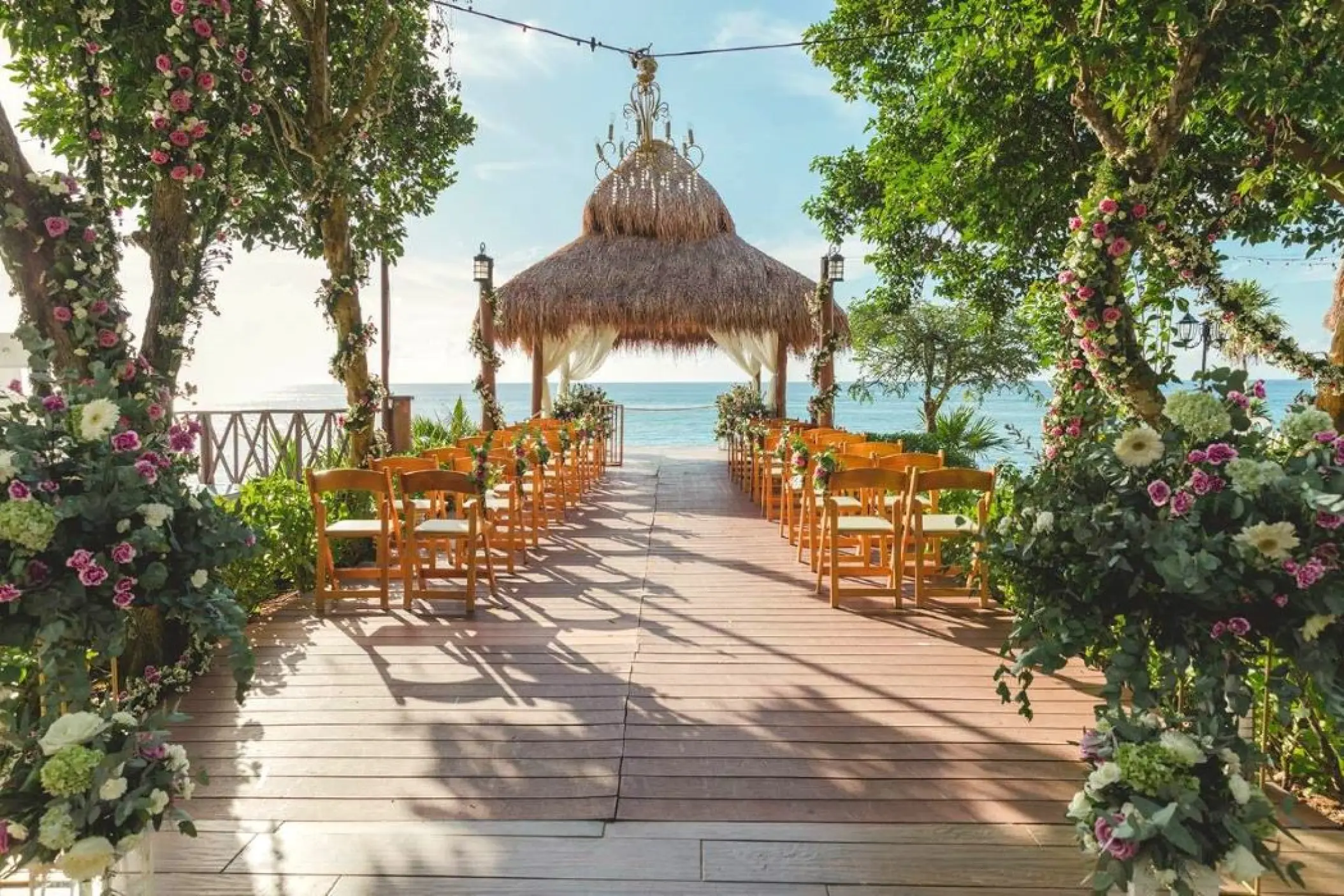Thatched roof gazebo wedding ceremony with ocean views at Dreams Cozumel Cape