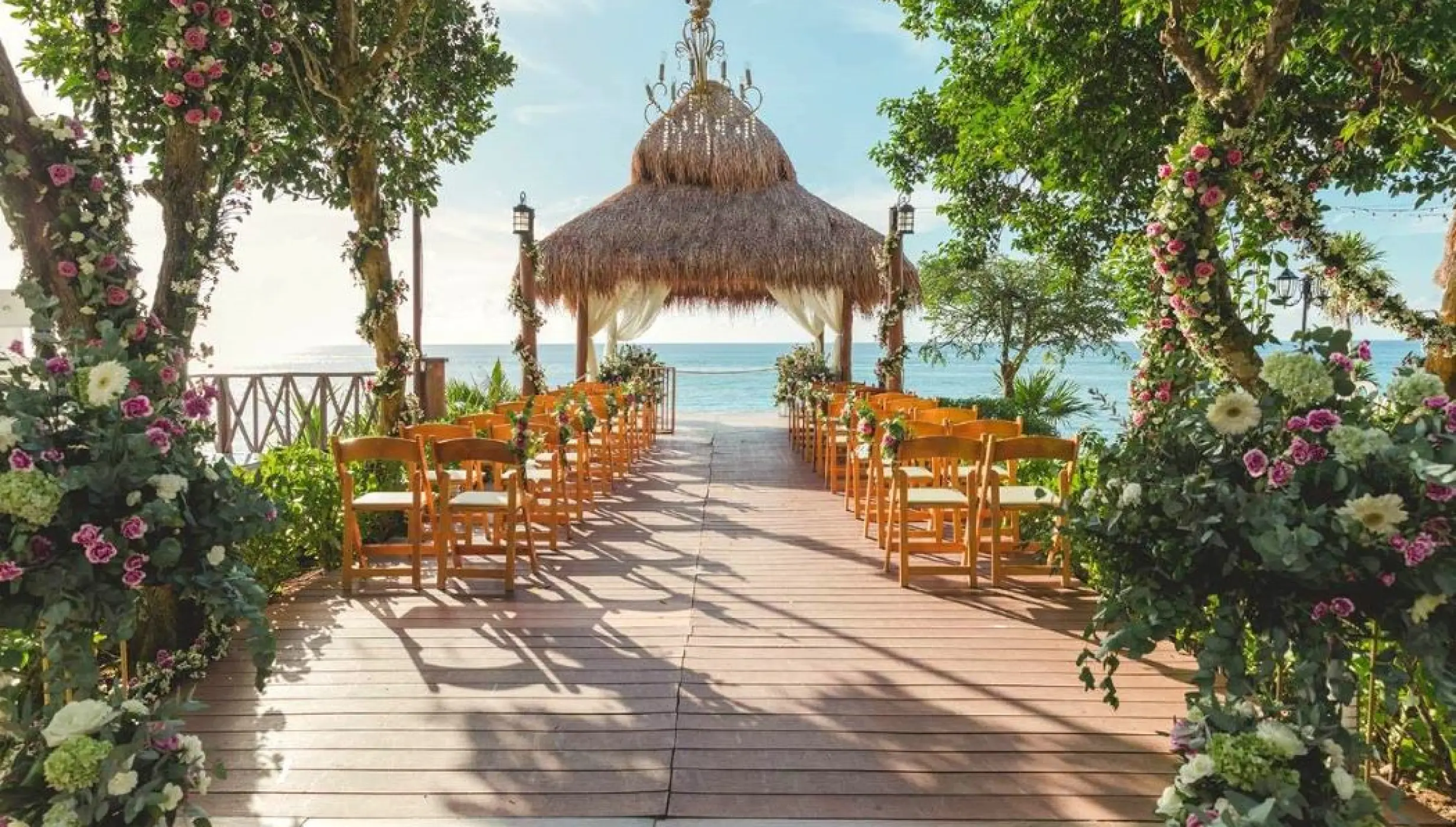 Thatched roof gazebo wedding ceremony with ocean views at Dreams Cozumel Cape