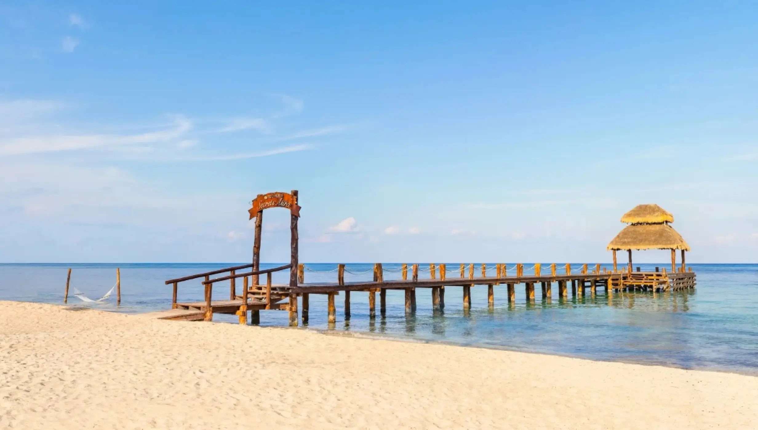 Wooden pier wedding venue with thatched gazebo at Secrets Aura, Cozumel