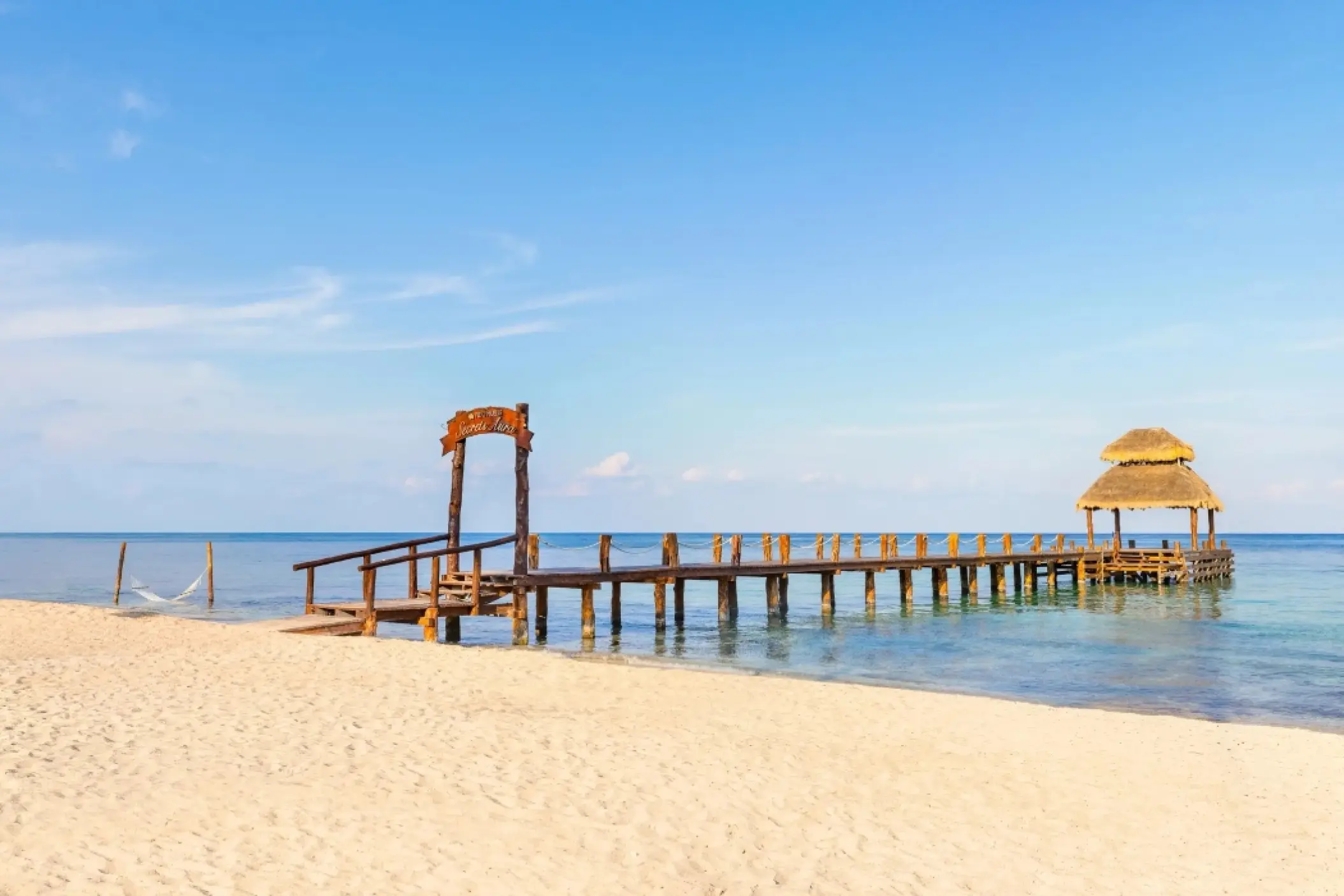 Wooden pier wedding venue with thatched gazebo at Secrets Aura, Cozumel