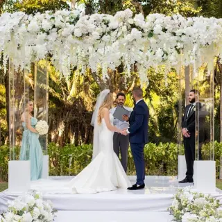 Wedding ceremony under a white floral arch at Secrets Bahia Mita, Puerto Vallarta