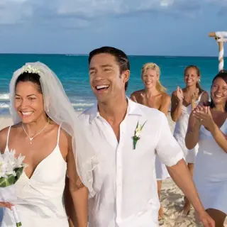 Bride and groom walking down the aisle after a beach wedding ceremony at Secrets Maroma Beach, Riviera Maya