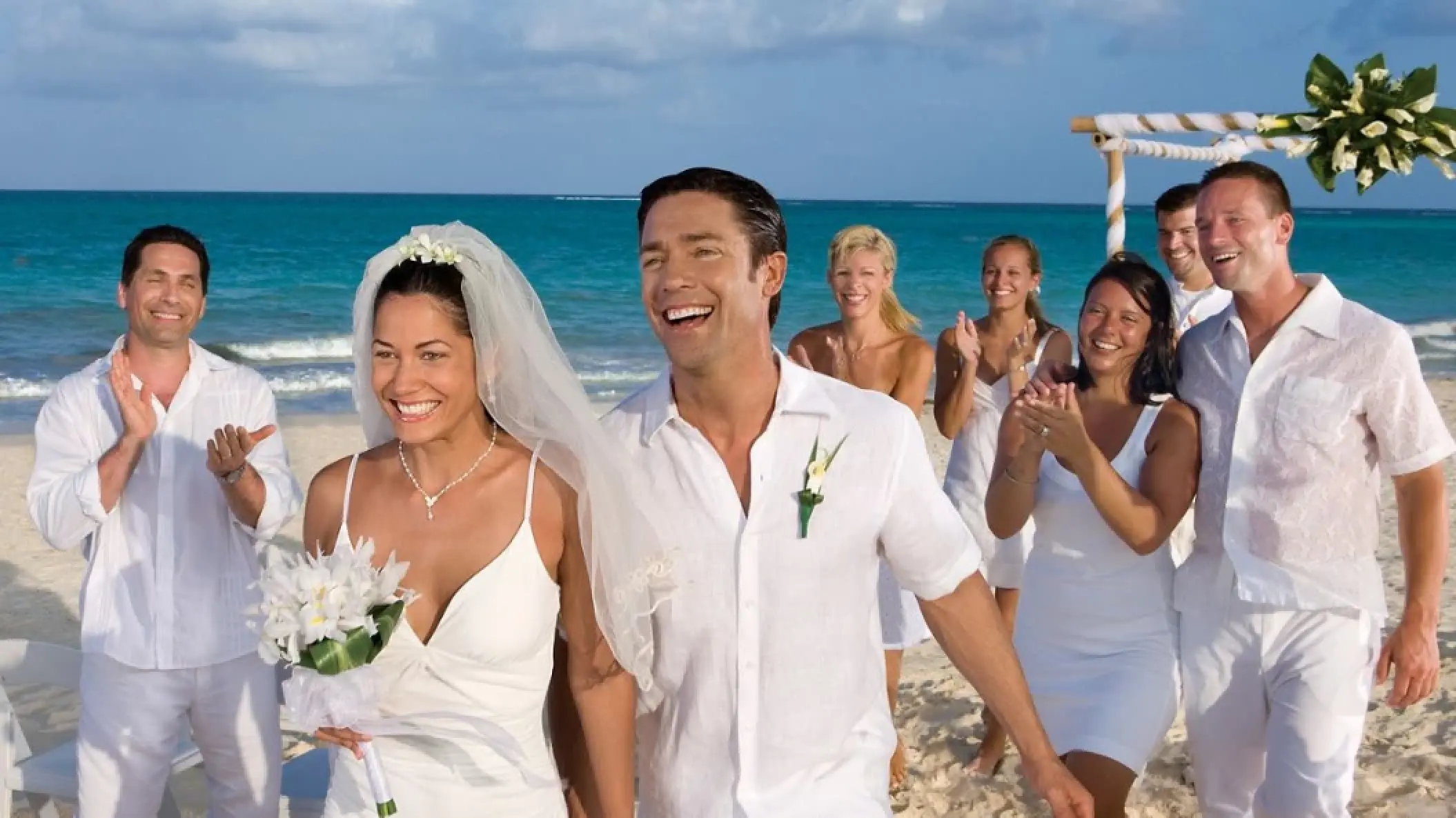 Bride and groom walking down the aisle after a beach wedding ceremony at Secrets Maroma Beach, Riviera Maya