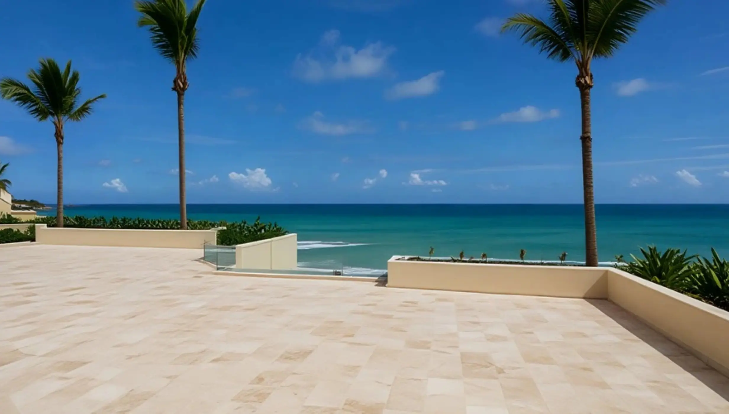 Beachfront terrace with palm trees overlooking the turquoise sea at Secrets Mirabel, Cancun