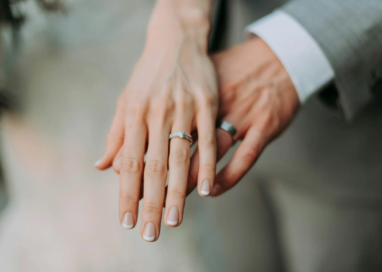bride and groom showing their wedding rings