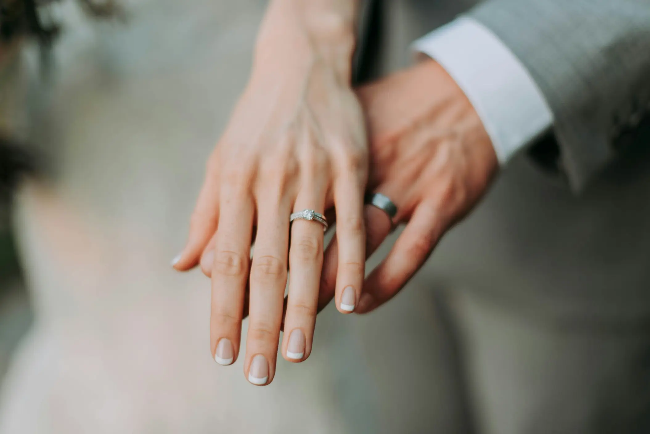 Close-up of the bride and groom showing their wedding rings at Secrets Mirabel, Cancun