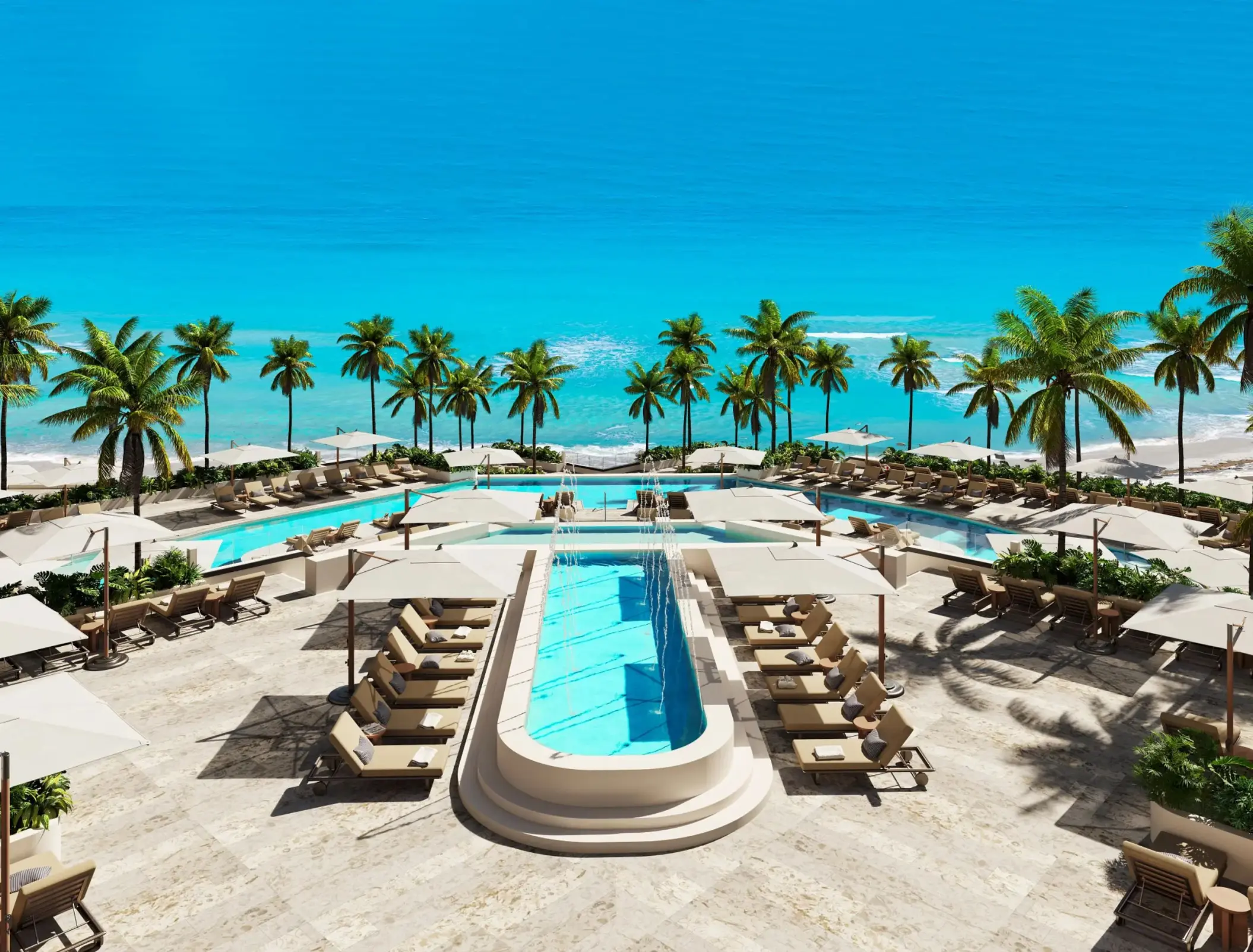 Secrets Mirabel pool deck with lounge chairs and palm trees by the ocean, Cancun