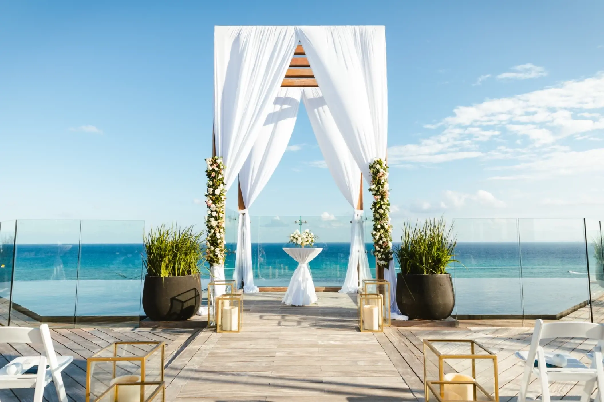Rooftop wedding ceremony setup with white drapery and ocean views at Secrets Moxche, Playa Del Carmen