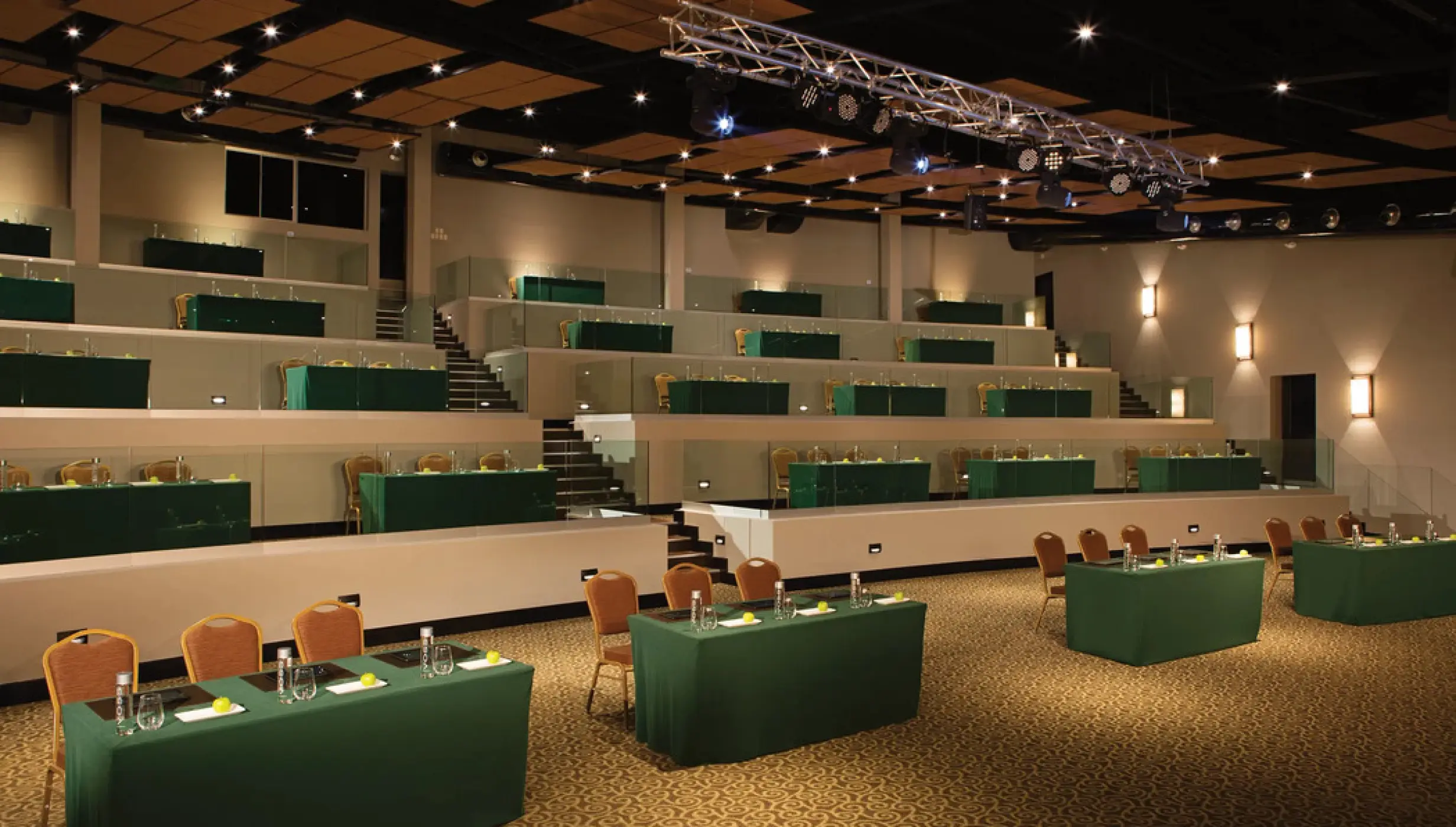 Amphitheater wedding reception venue with tiered seating and green tables at Secrets Papagayo, Papagayo
