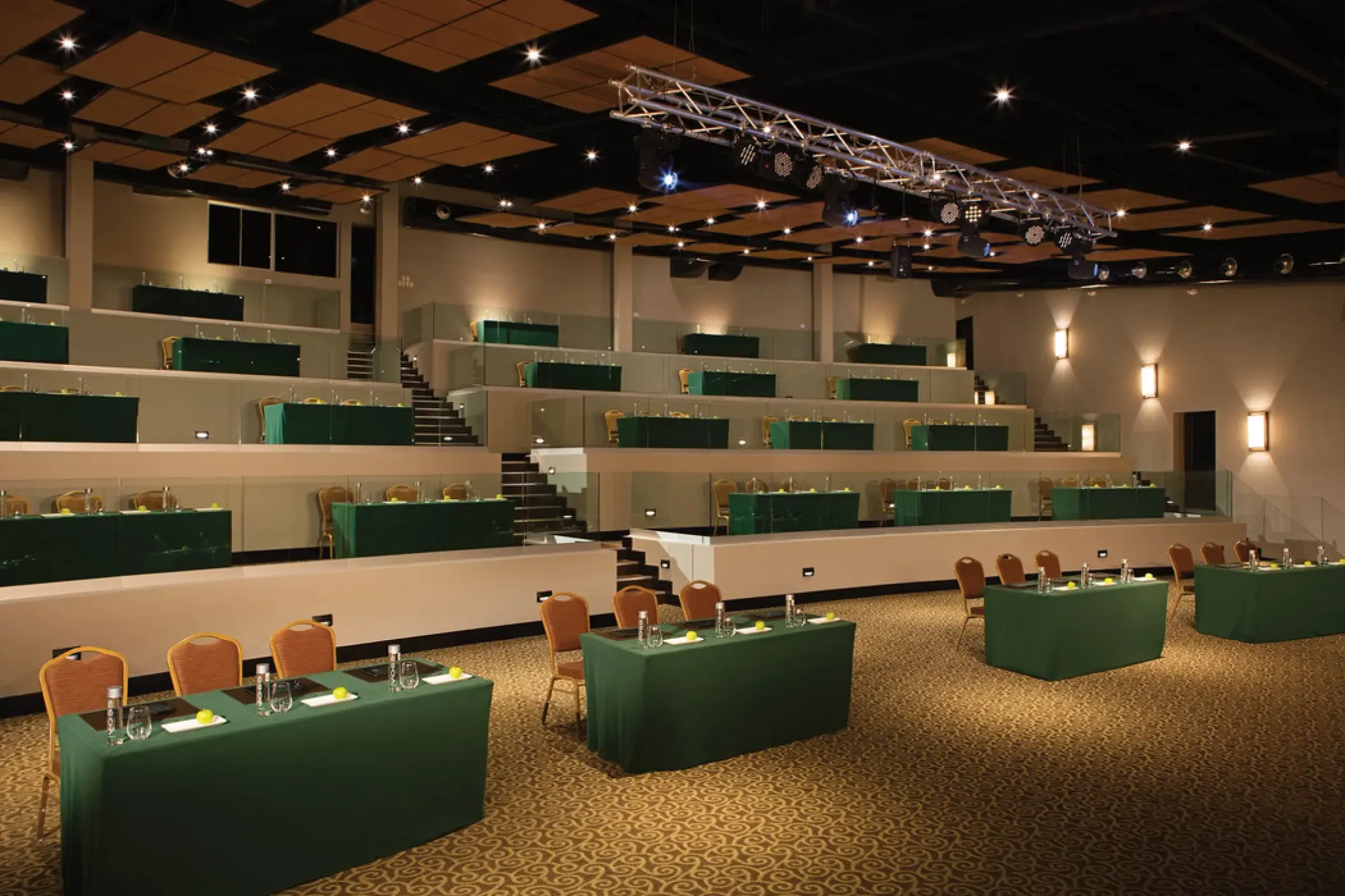 Amphitheater wedding reception venue with tiered seating and green tables at Secrets Papagayo, Papagayo
