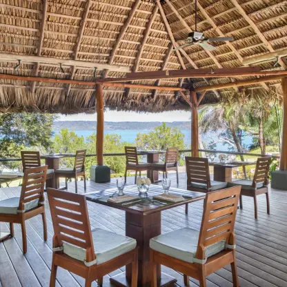 Open-air Aqua restaurant under a thatched palapa roof at Secrets Papagayo, Papagayo