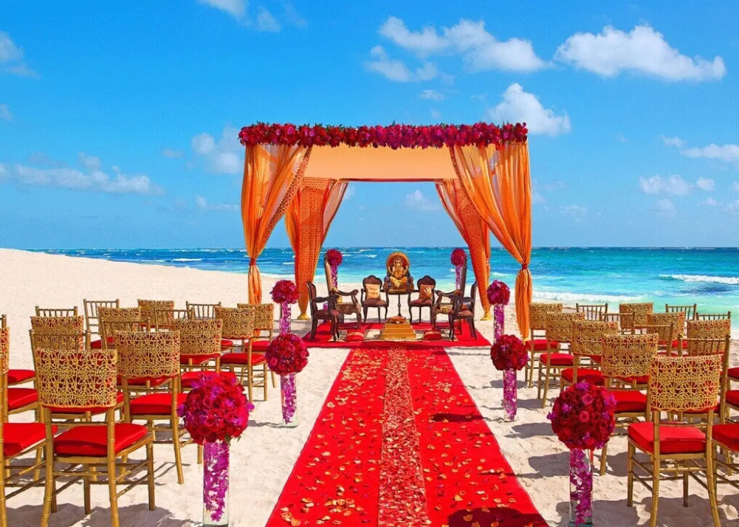 South Asian beach wedding ceremony with orange mandap and red aisle at Secrets Papagayo, Costa Rica