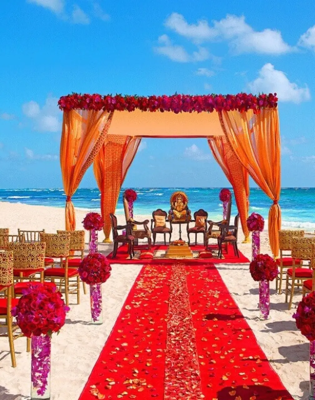 South Asian beach wedding ceremony with orange mandap and red aisle at Secrets Papagayo, Costa Rica