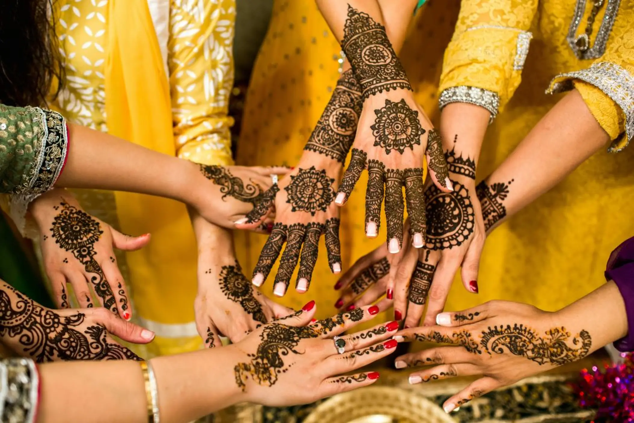 Intricate henna designs on hands during a South Asian wedding mehendi at Secrets Papagayo, Costa Rica