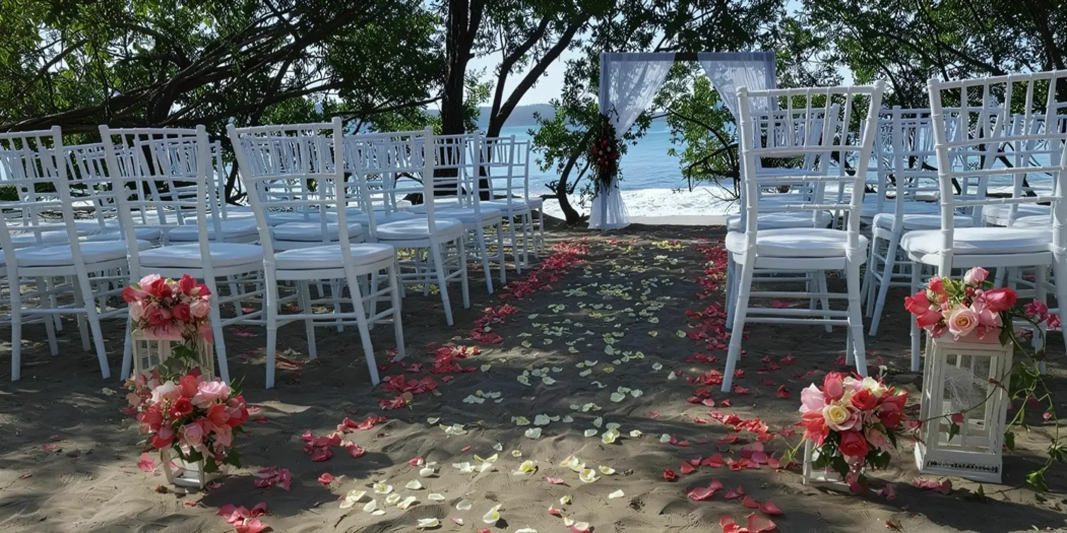 Beachfront wedding ceremony with white chairs and floral petal aisle at Secrets Papagayo, Papagayo