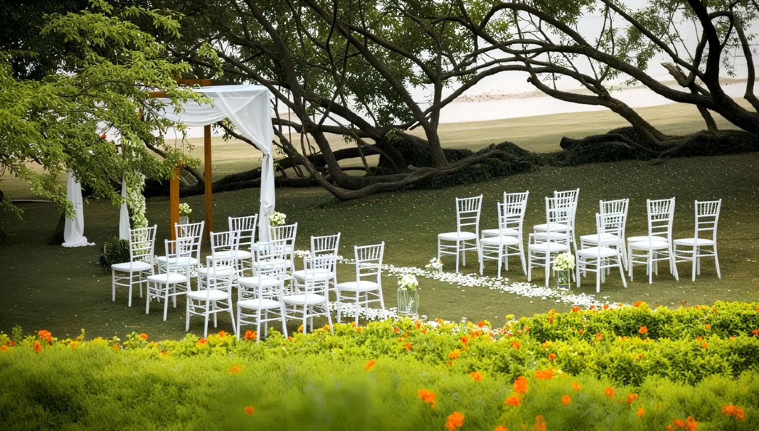 Spa garden wedding ceremony with white chairs and gazebo at Secrets Papagayo, Papagayo