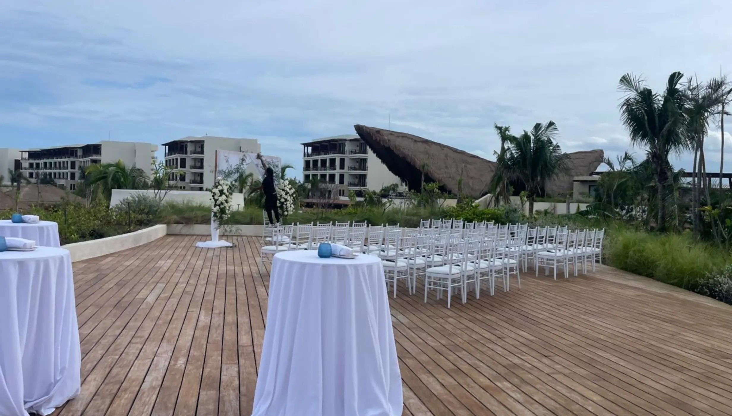 Portofino rooftop wedding ceremony setup with white chairs at Secrets Playa Blanca, Cancun