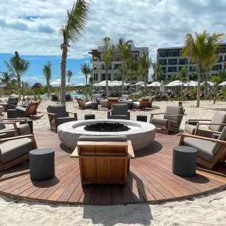 Sea side terrace reception venue with a central fire pit at Secrets Playa Blanca, Cancun
