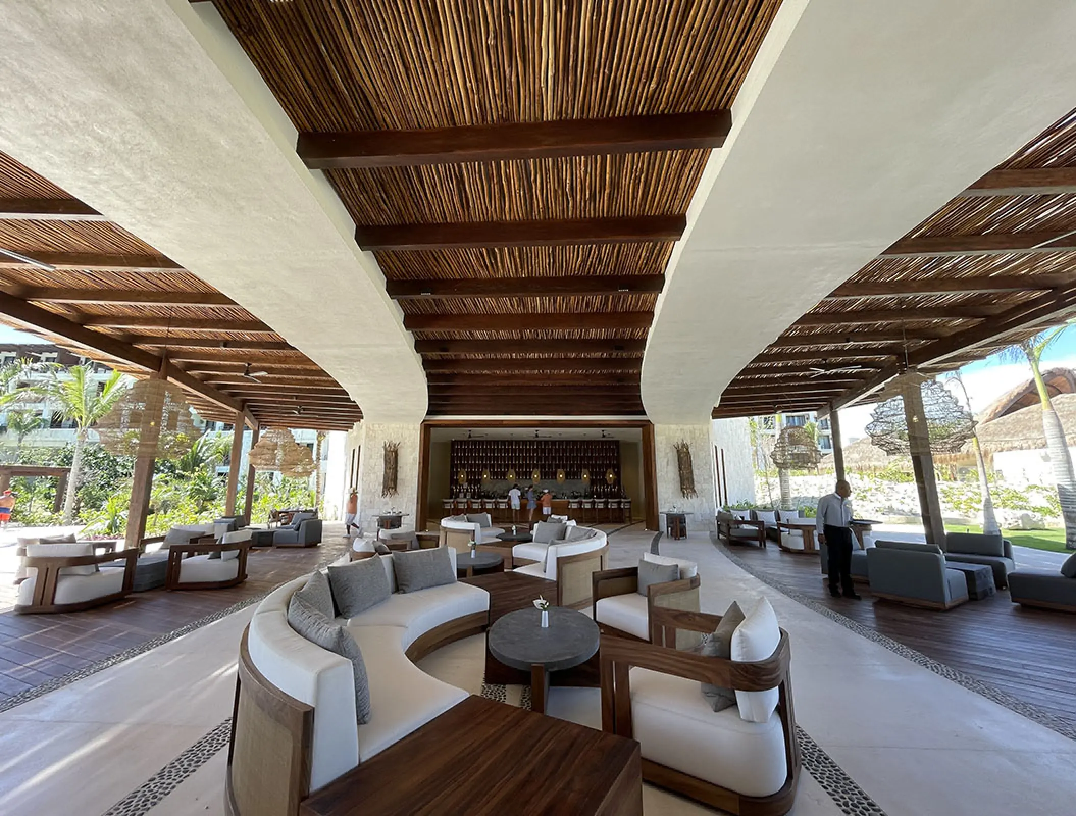 Preferred Club terrace lounge with modern seating under a wood-beamed ceiling at Secrets Playa Blanca, Cancun